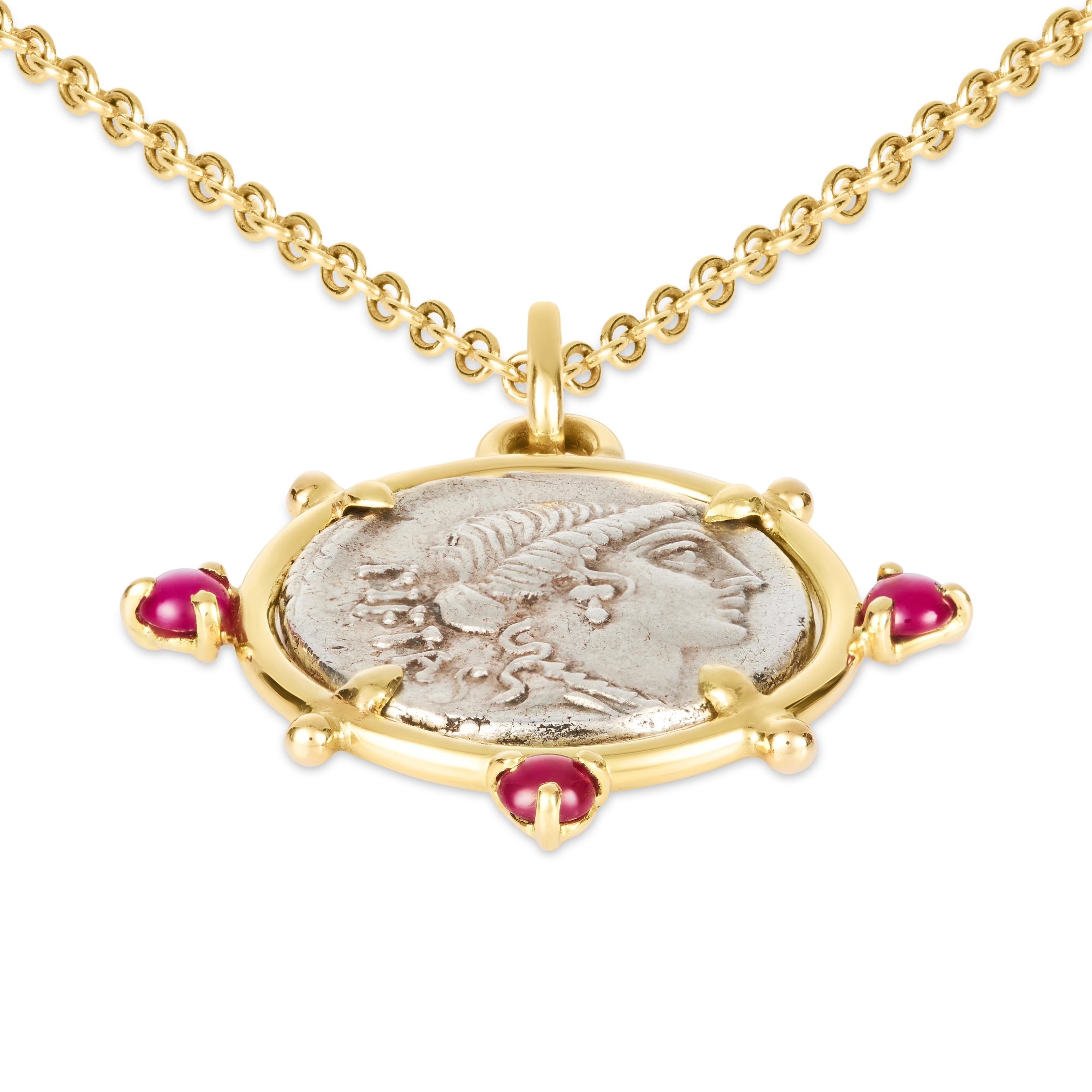 This DUBINI coin necklace from the 'Empires' collection features an authentic Roman denarius silver coin dating circa 74 B.C. set in 18kt yellow gold with peridot and citrine cabochons.

Included is a 47cm chain in 18kt yellow gold.

Depicted on the