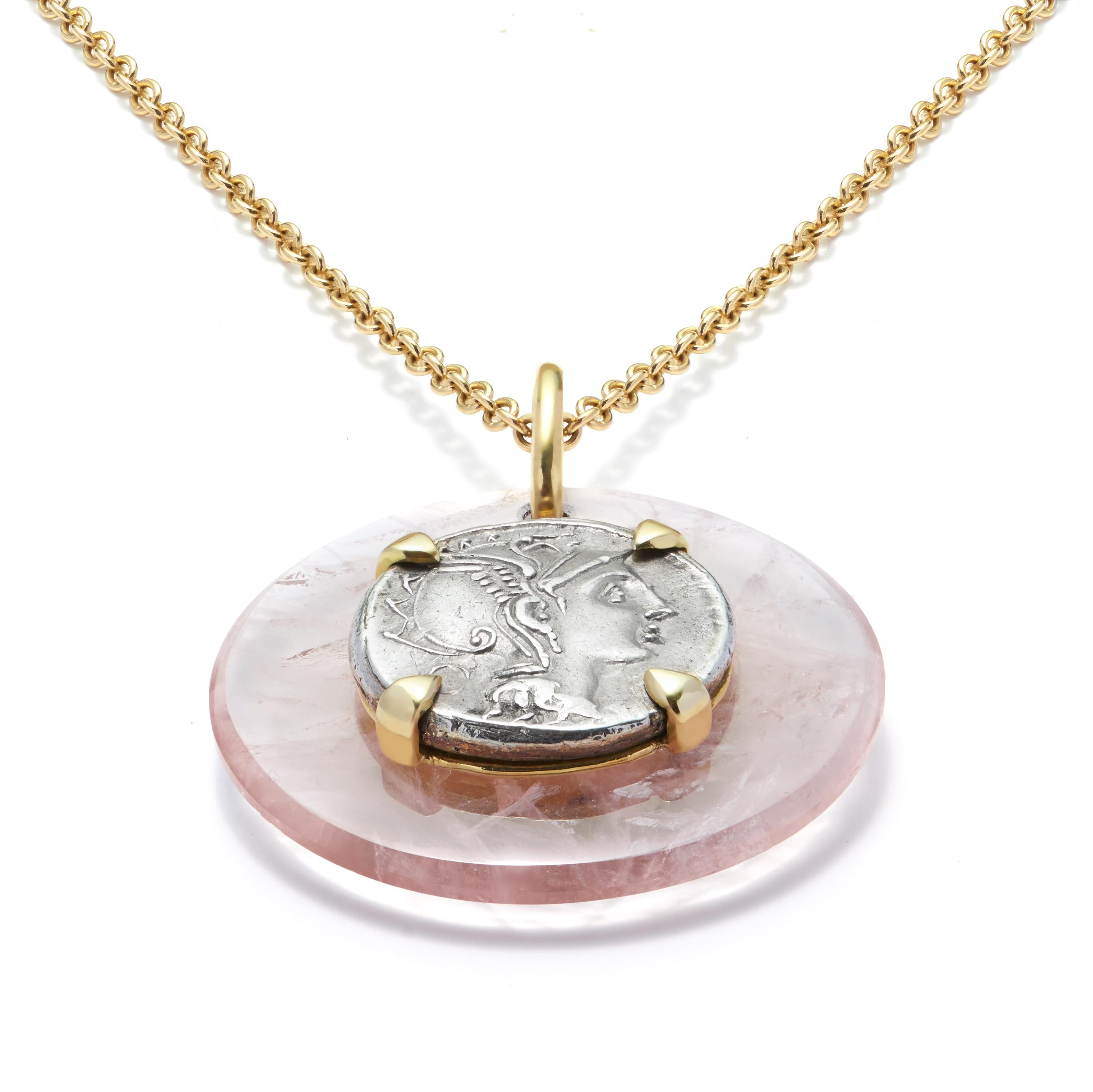 This DUBINI coin necklace from the 'Empires' collection features an authentic Roman denarius silver coin circa 111-110 B.C. set in 18kt gold on a rose quartz disc suspended on a rolo chain with a lobster clasp closure and an adjustable fit.

Disc
