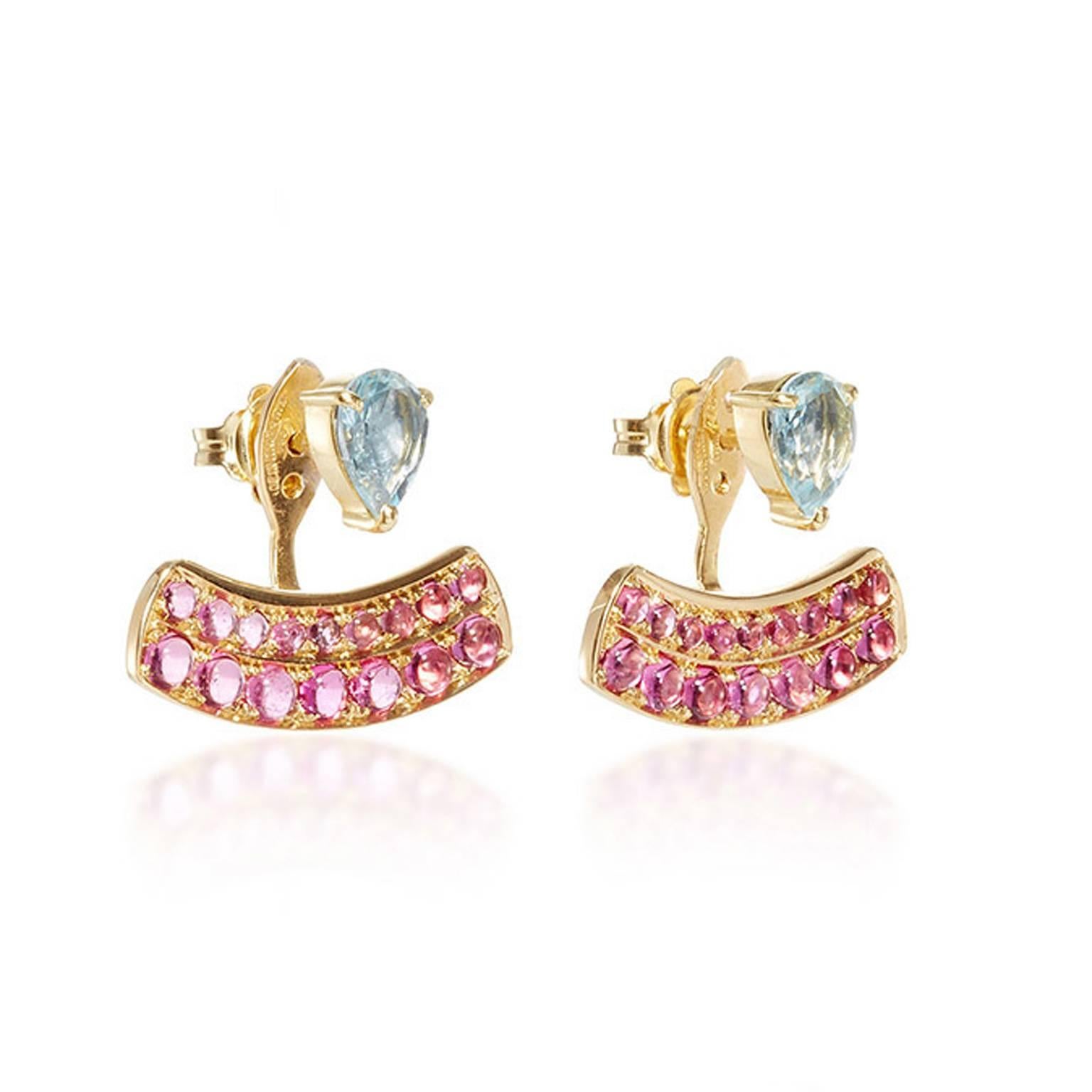 These DUBINI earrings from the 'Theodora' collection feature aquamarine drops with rubellite cabochons set in 18K yellow gold. 

Handmade in Rome, they are punctuated with three holes for an adjustable fit. Can be worn as a single stud or together
