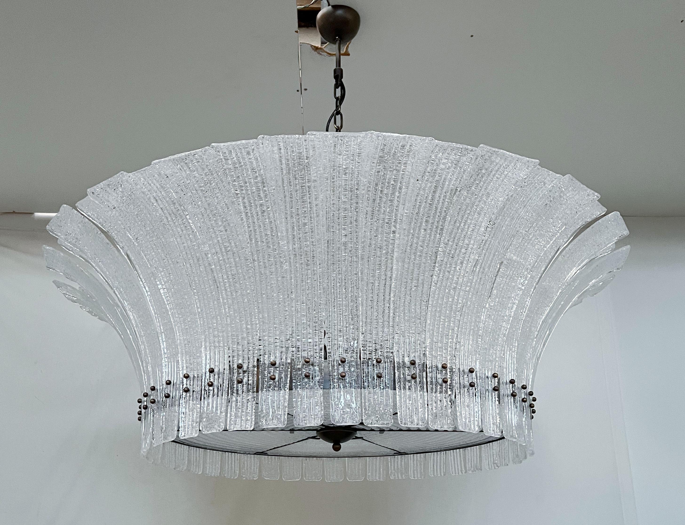 Italian modern chandelier with clear Murano glass leaves hand blown with textured granular effect using Graniglia technique, mounted on bronzed finish frame / Made in Italy
12 lights / E26 type or E27 type / max 60W each
Measures: diameter 47