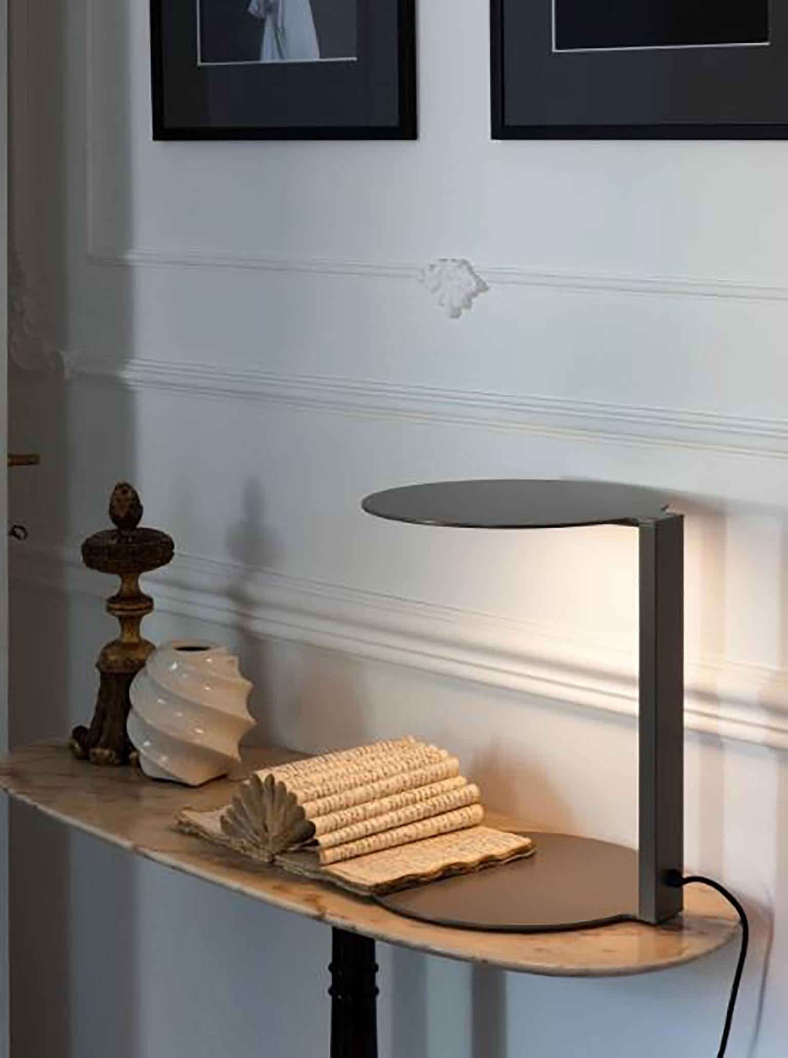 Duca table lamp designed by Nicola Gallizia for Oluce. This lamp is a great example of a unique, modern, and practical design which could be the perfect bedside table lamp. Its light is cast downwards which is preferred for a side table lamp,