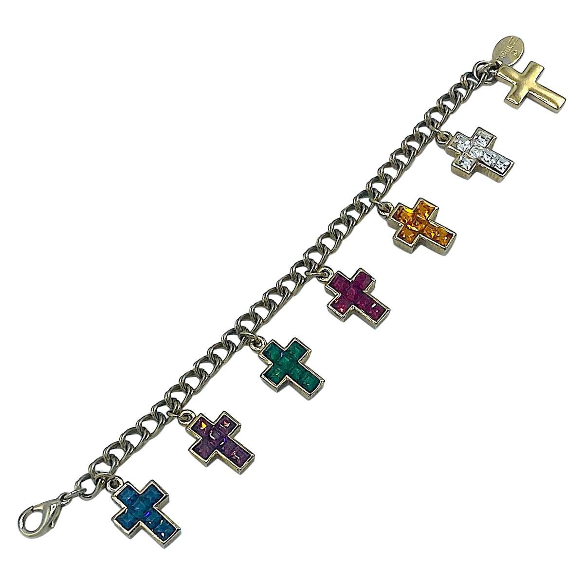 A charming replica of Wallace Simpson's, the Duchess of Windsor's, 1936 Cartier gold and jeweled cross charm bracelet by American fashion jewelry company Carolee. This pieces is gold plate with Swarovski rhinestones and an oval plaque inscribed