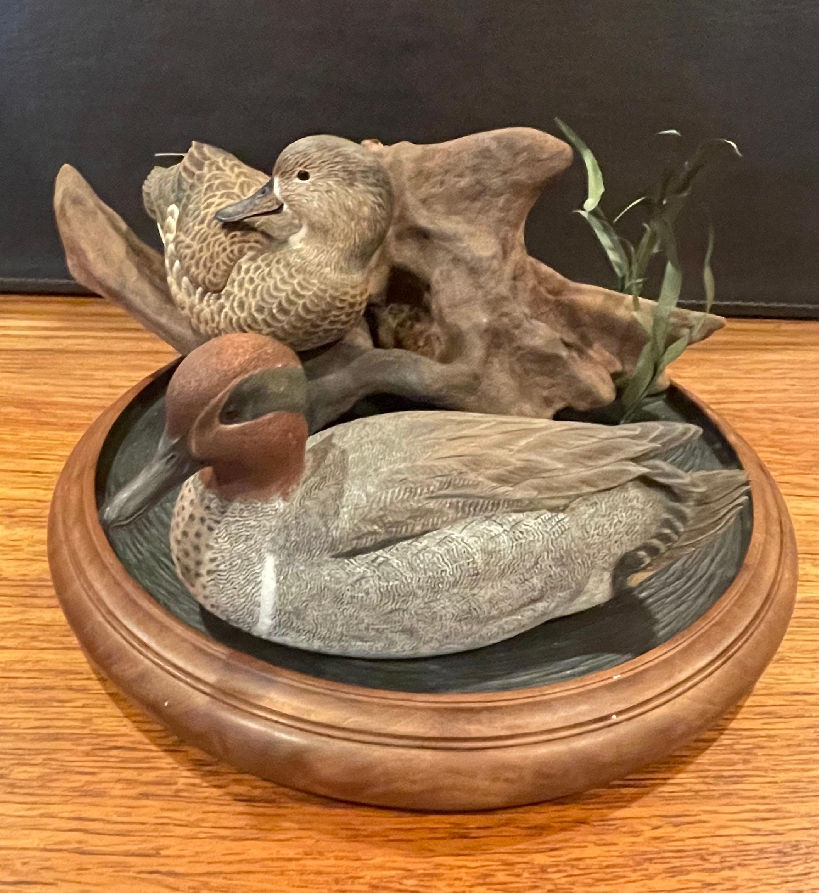 A very cool and unique duck decoy three-piece sculpture by Herb Watson, circa 1987. The detail, craftsmanship and painting of the ducks is amazing; they look absolutely real! The set includes a green winged teal drake and hen (3.25