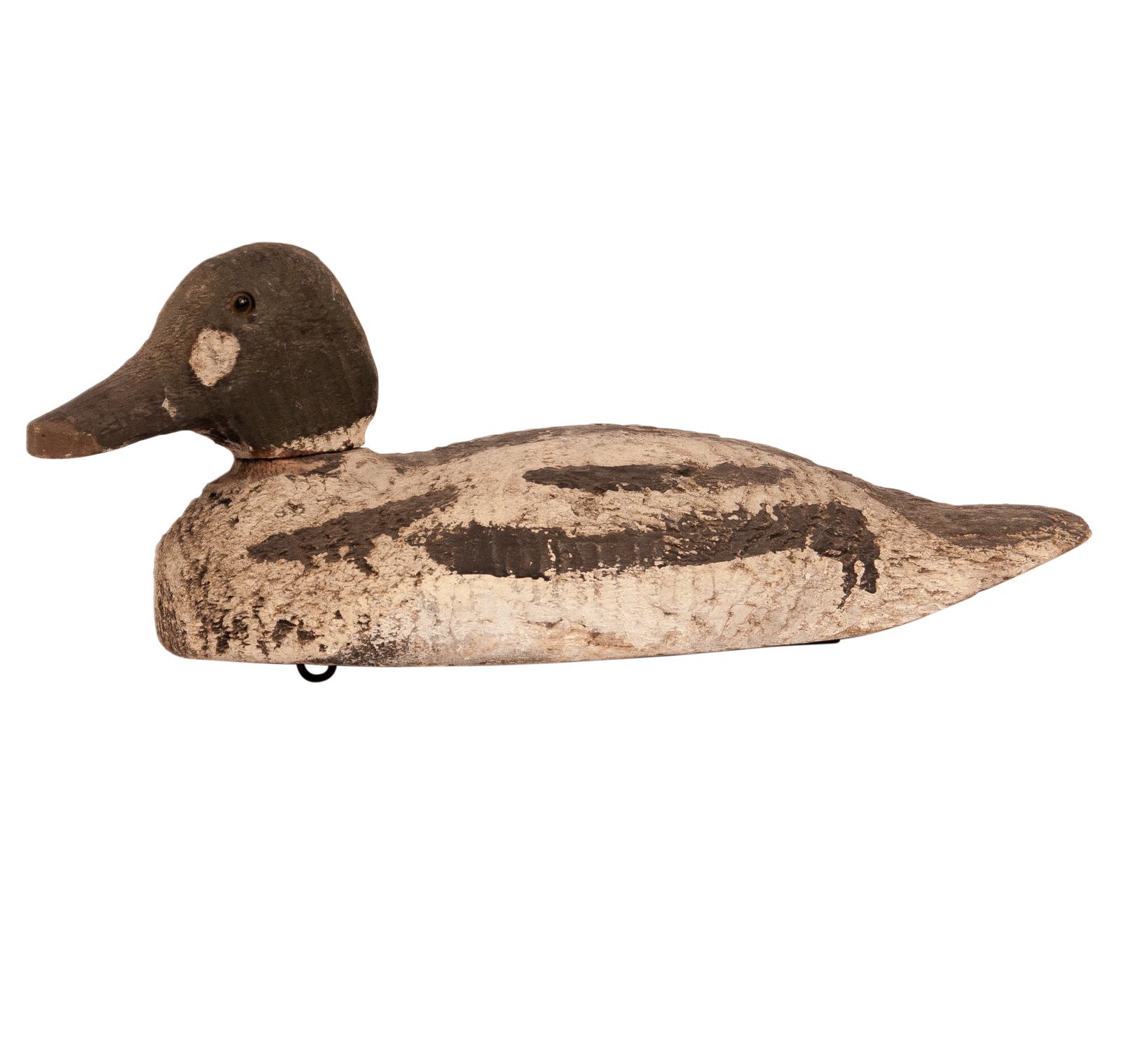 An early 20th century American wood and painted duck decoy, circa 1920. Nice old paint with good carving. Strip of metal to weight the carving so it would float properly.