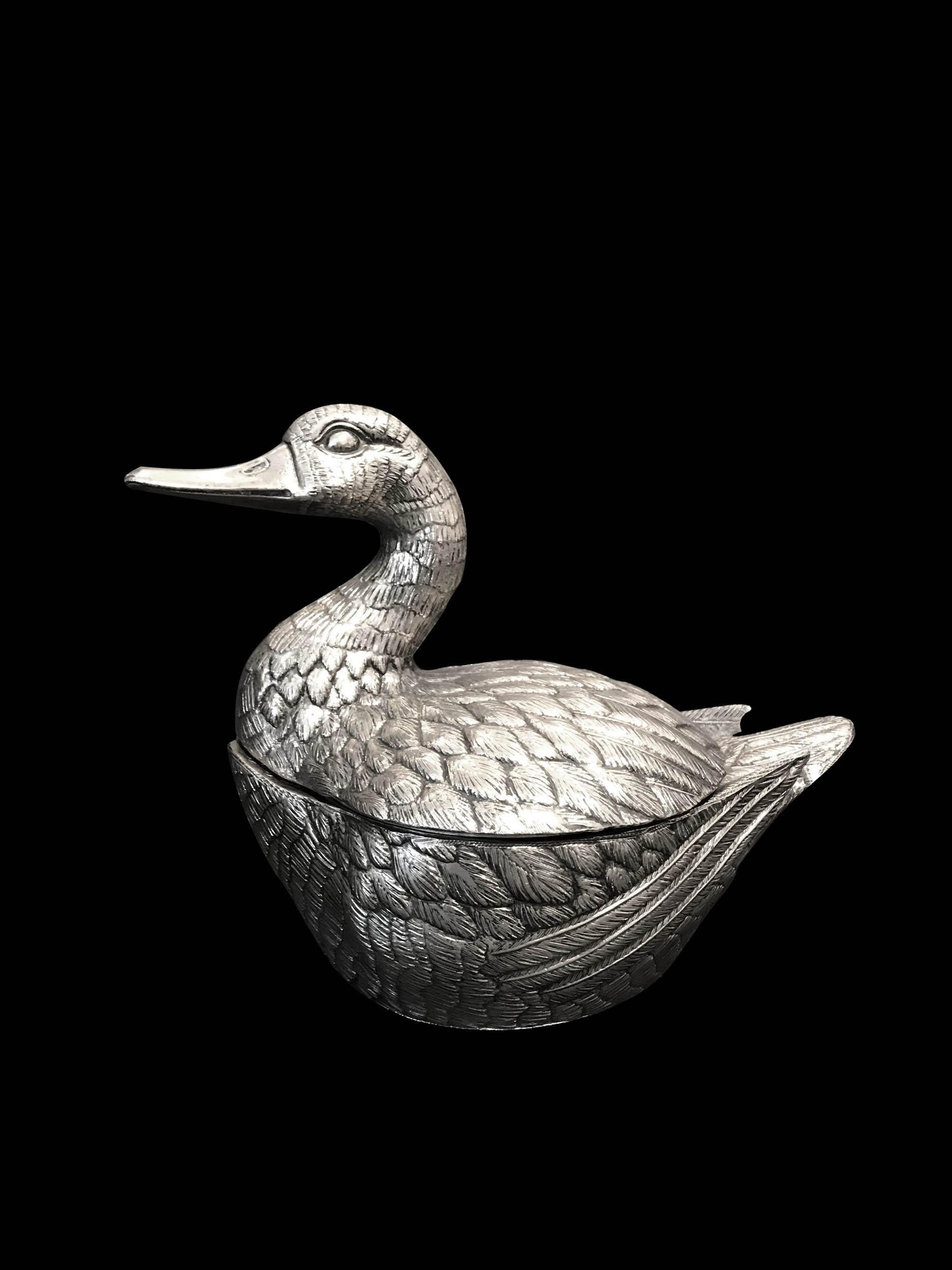 This duck ice bucket was designed by Mauro Manetti circa 1960. 
The original and first productions, like this one, had the inside made of metal and the outside of silvered cast aluminum which is silver plated.
Mark on one side of the tail 