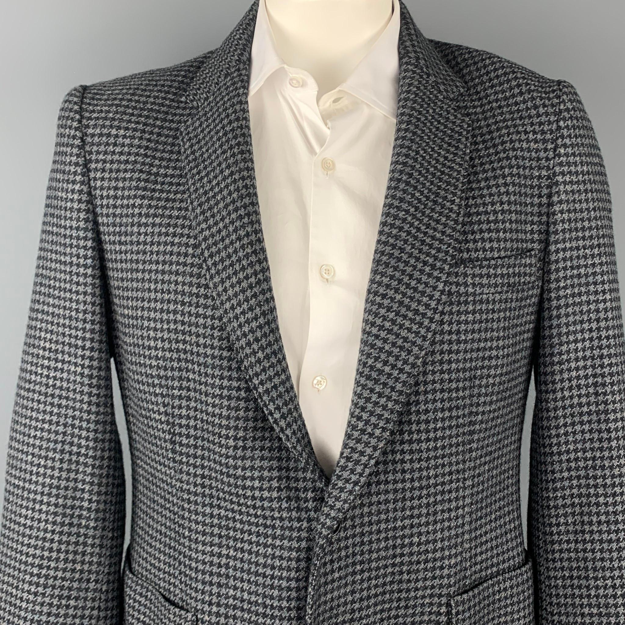 DUCKIE BROWN sport coat comes in a gray & black houndstooth wool blend with a full liner featuring a notch lapel, patch pockets, and a two button closure. Made in USA.

Good Pre-Owned Condition.
Marked: 44

Measurements:

Shoulder: 18.5 in.
Chest: