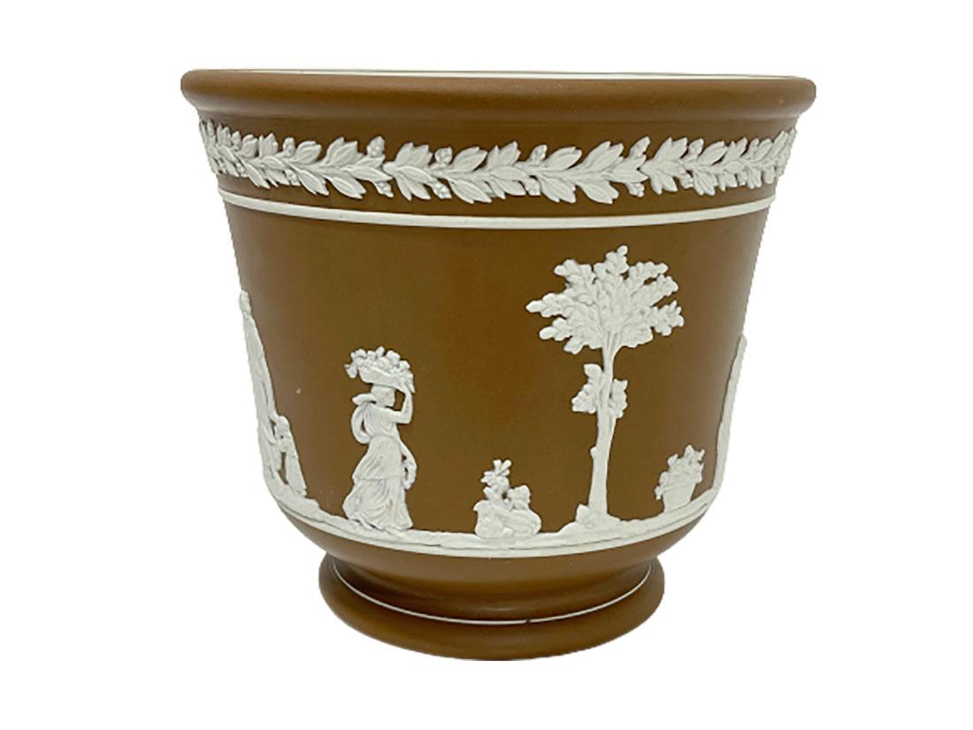 Dudson Brothers of Hanley England Jasperware cache pot

Brown cache pot decorated with white classical scene, raised on foot rim 
Marked on the bottom 