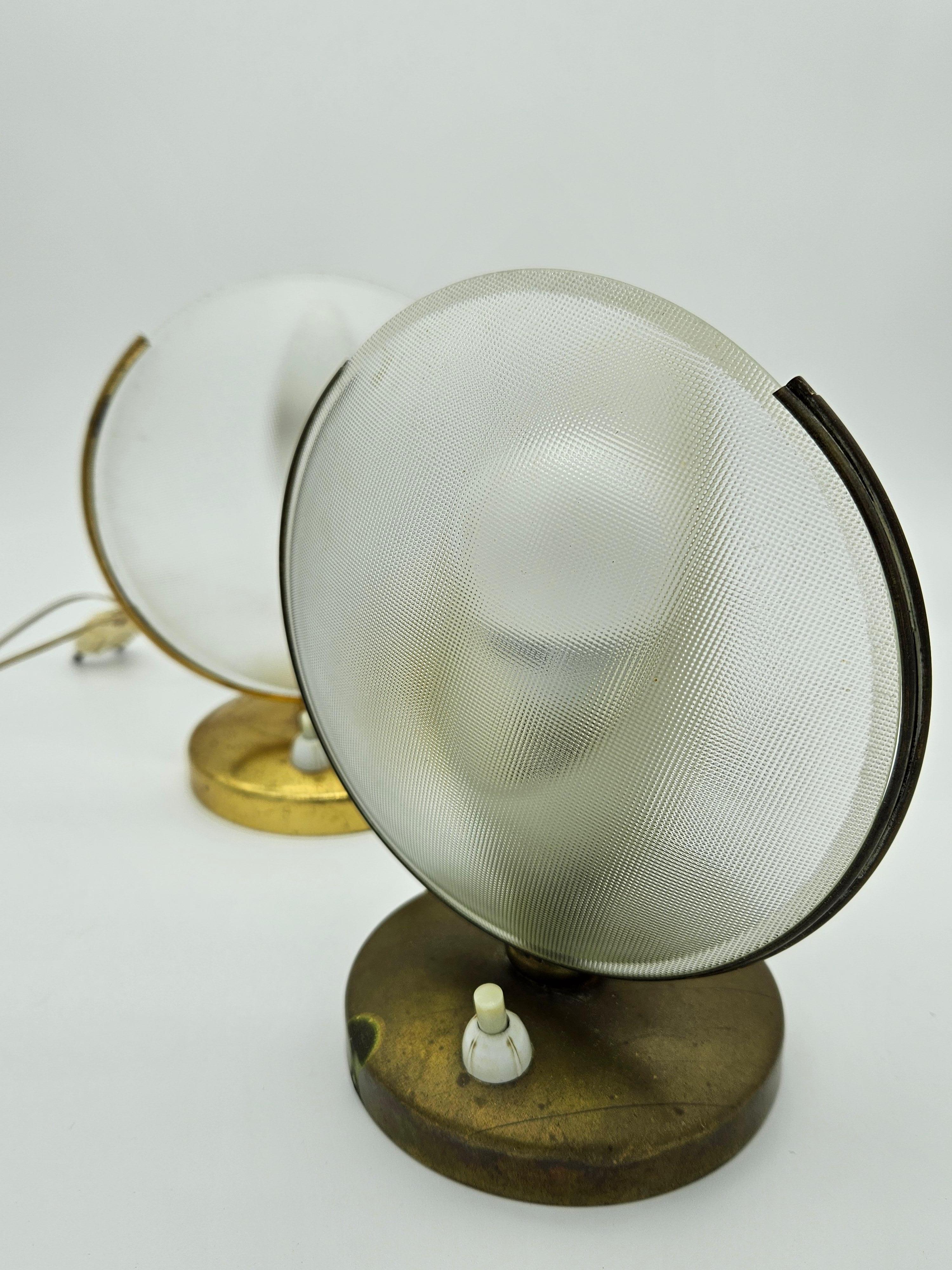 Pair of 1970s Italian abat jour with brass base and glass bowl with brass border.

One abat jour is missing the glass covering the bulb.

One of them has the original cable of the time, so it should be replaced as it is obsolete but still