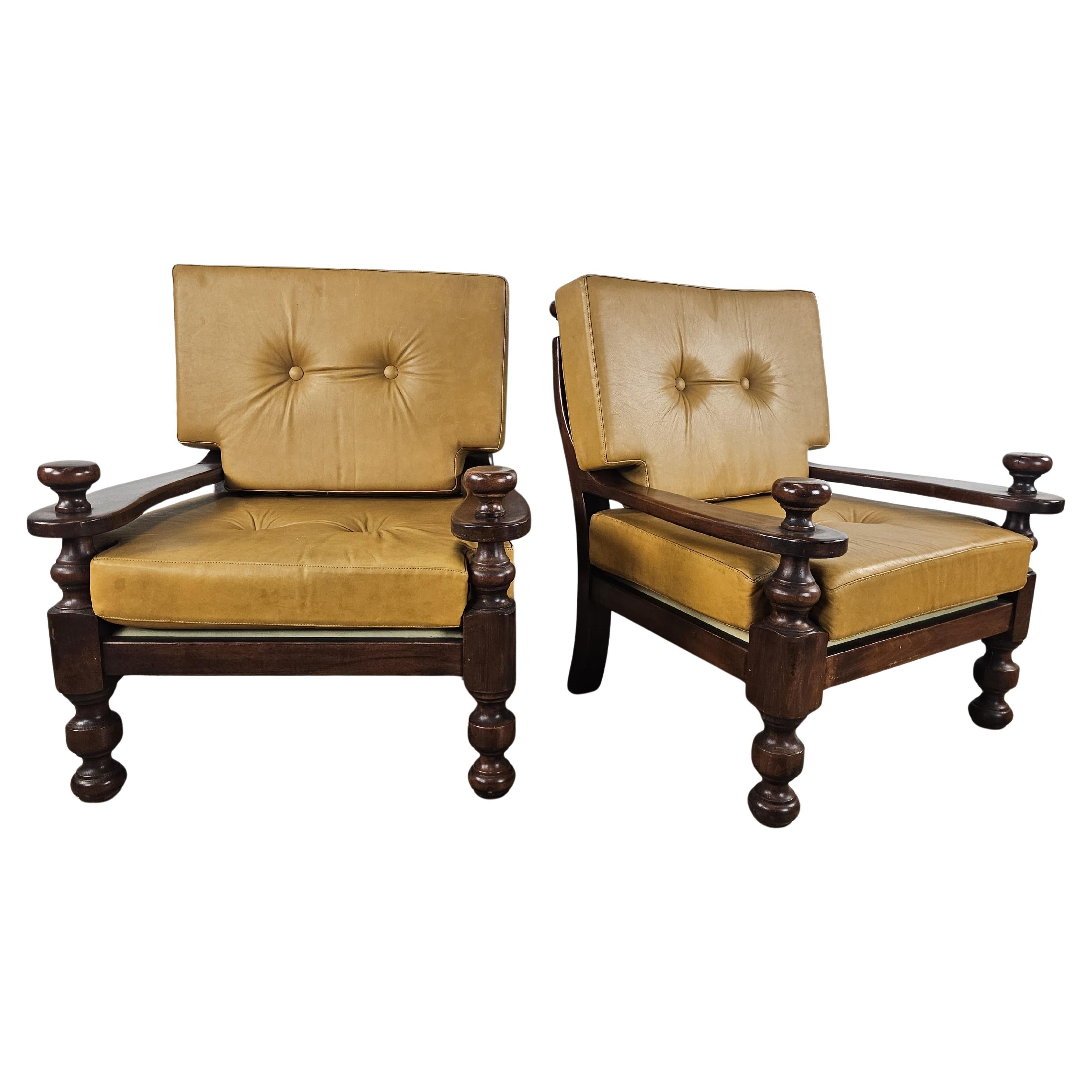 Two large 1980s solid wood and leather armchairs