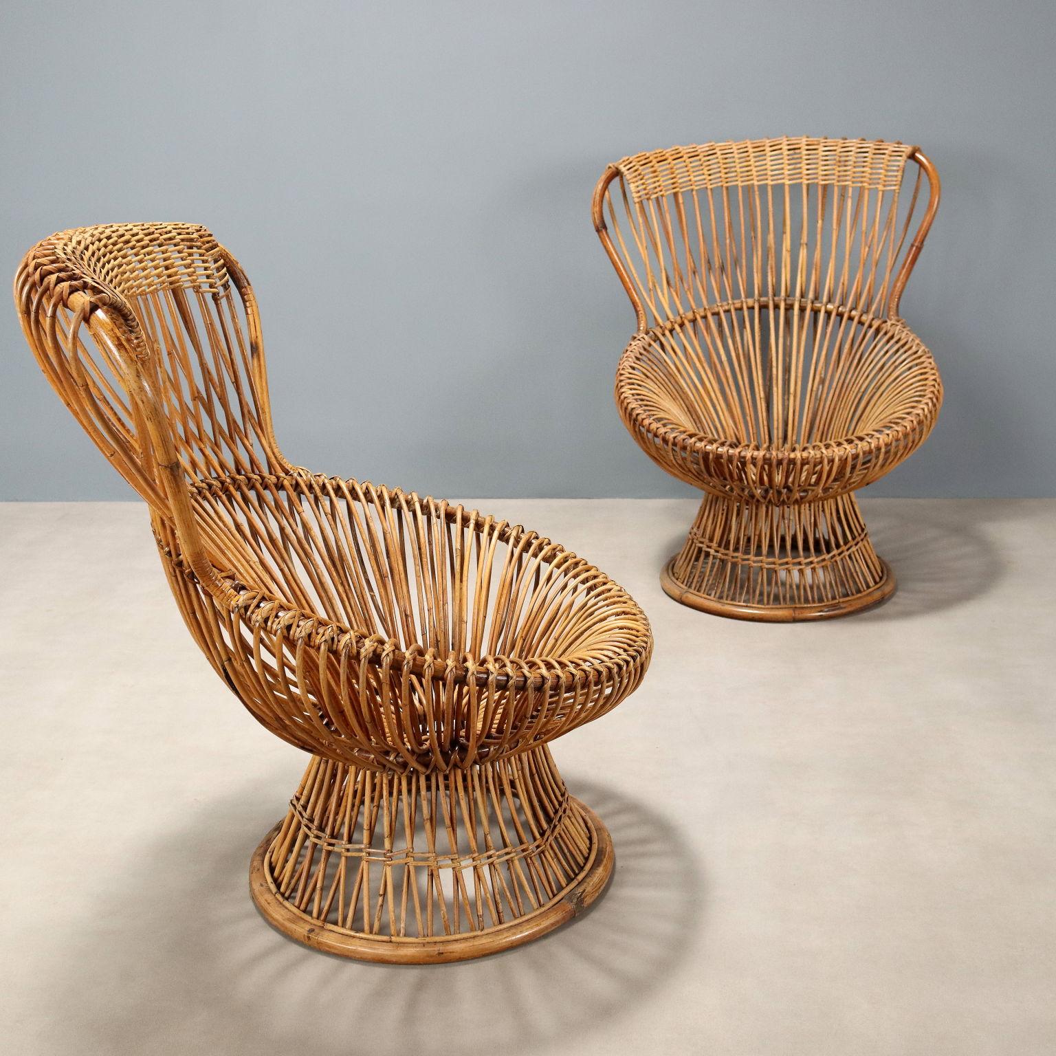 Pair of iconic armchairs model 'Margherita' winner of the gold medal at the IX Triennale; designed by Franco Albini, they feature a wooden frame, weave and weave in guinea cane. In good overall condition with signs of time, cushions absent.
