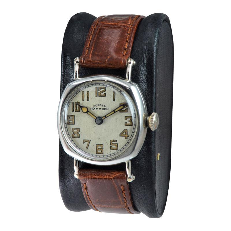 FACTORY / HOUSE: Deuber Hampden Watch Company
STYLE / REFERENCE: Cushion Shape / Campaign Style
METAL / MATERIAL: Nickel Silver
CIRCA / YEAR: 1920's
DIMENSIONS / SIZE: 39mm X 29mm
MOVEMENT / CALIBER: Manual Winding / 15 Jewels 
DIAL / HANDS: