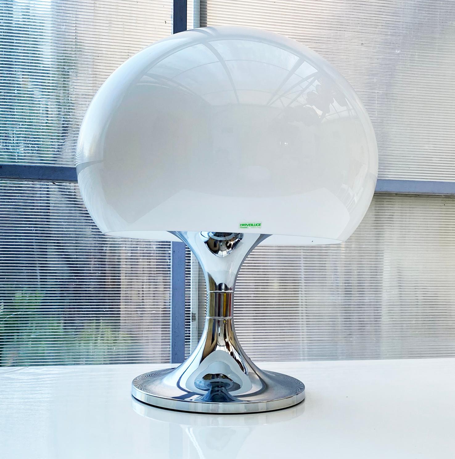 Duetto lamp by Luigi Massoni produced only from 1972 to 1976
Publisher: Harveiluce (Harvey Guzzini)
Color: white and chrome
Materials: Chrome round concave base and stem. . Mushroom globe shade in white acrylic. Chrome lid and ornamental nut on