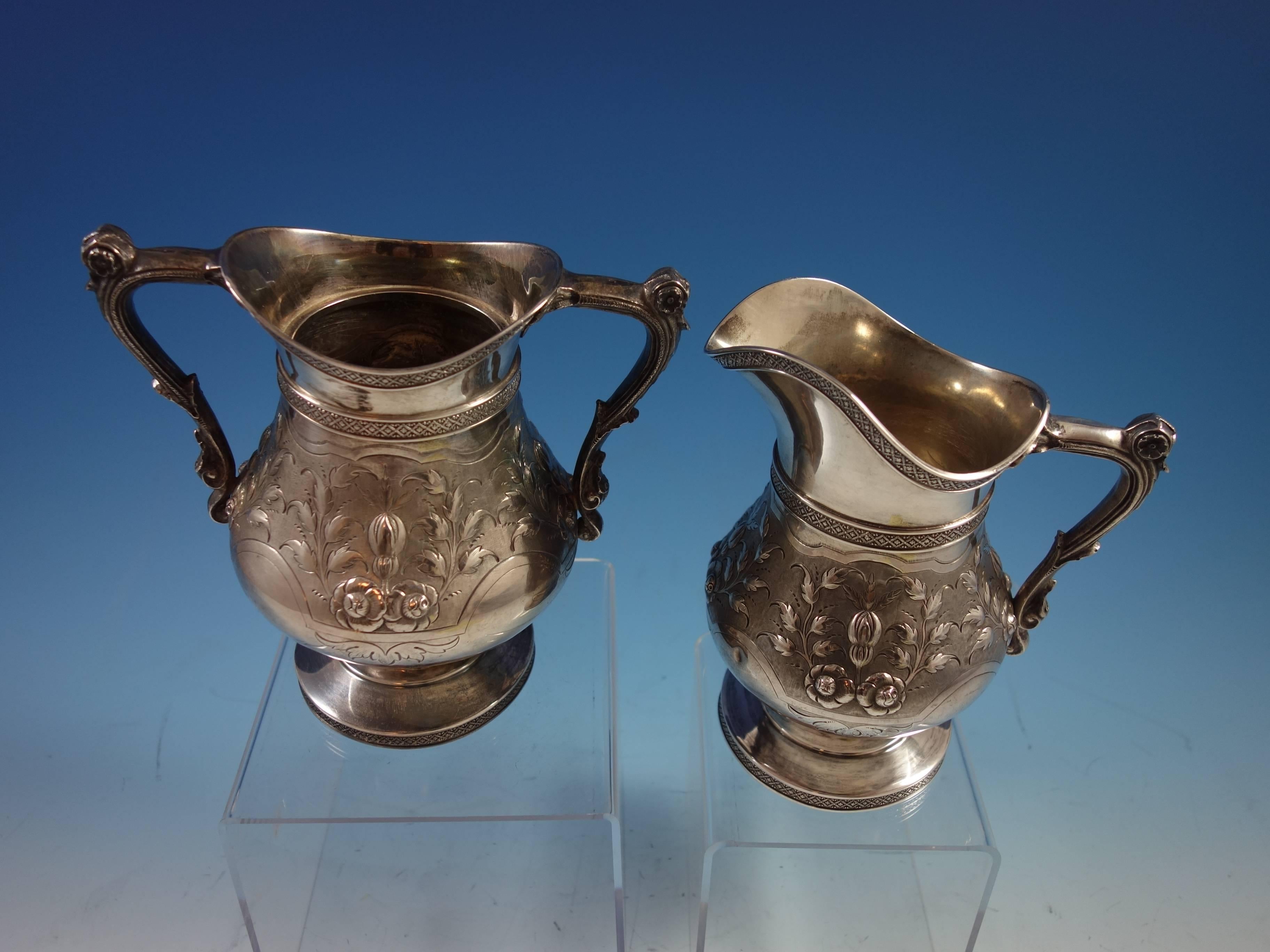 Impressive sterling two-piece sugar and creamer made by Duhme of Cincinnati, OH. The pieces have a beautiful floral repoussed and chased design. The sugar measures 6 3/4