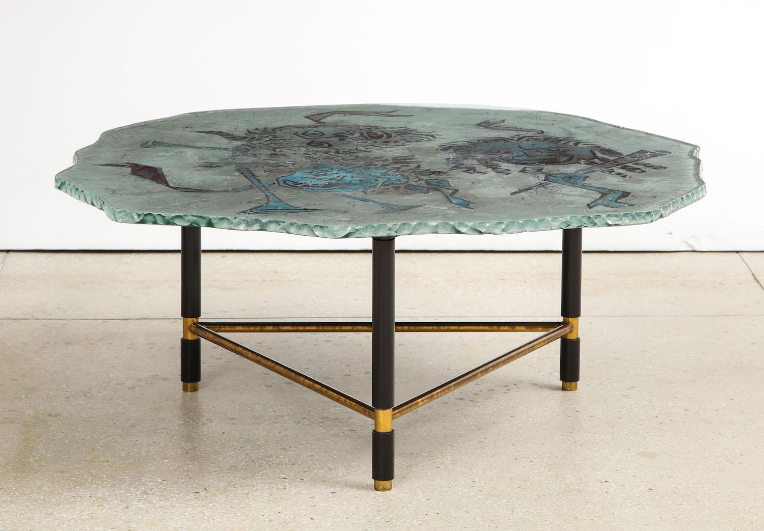 Cocktail table by Duilio Barnabé for Fontana Arte. Back-painted glass top of irregular shape and “chipped” edges. Triangular-shaped base of brass and black-painted metal. Signed “Dubé/ Fontana Arte.” Very good vintage condition with overall wear and