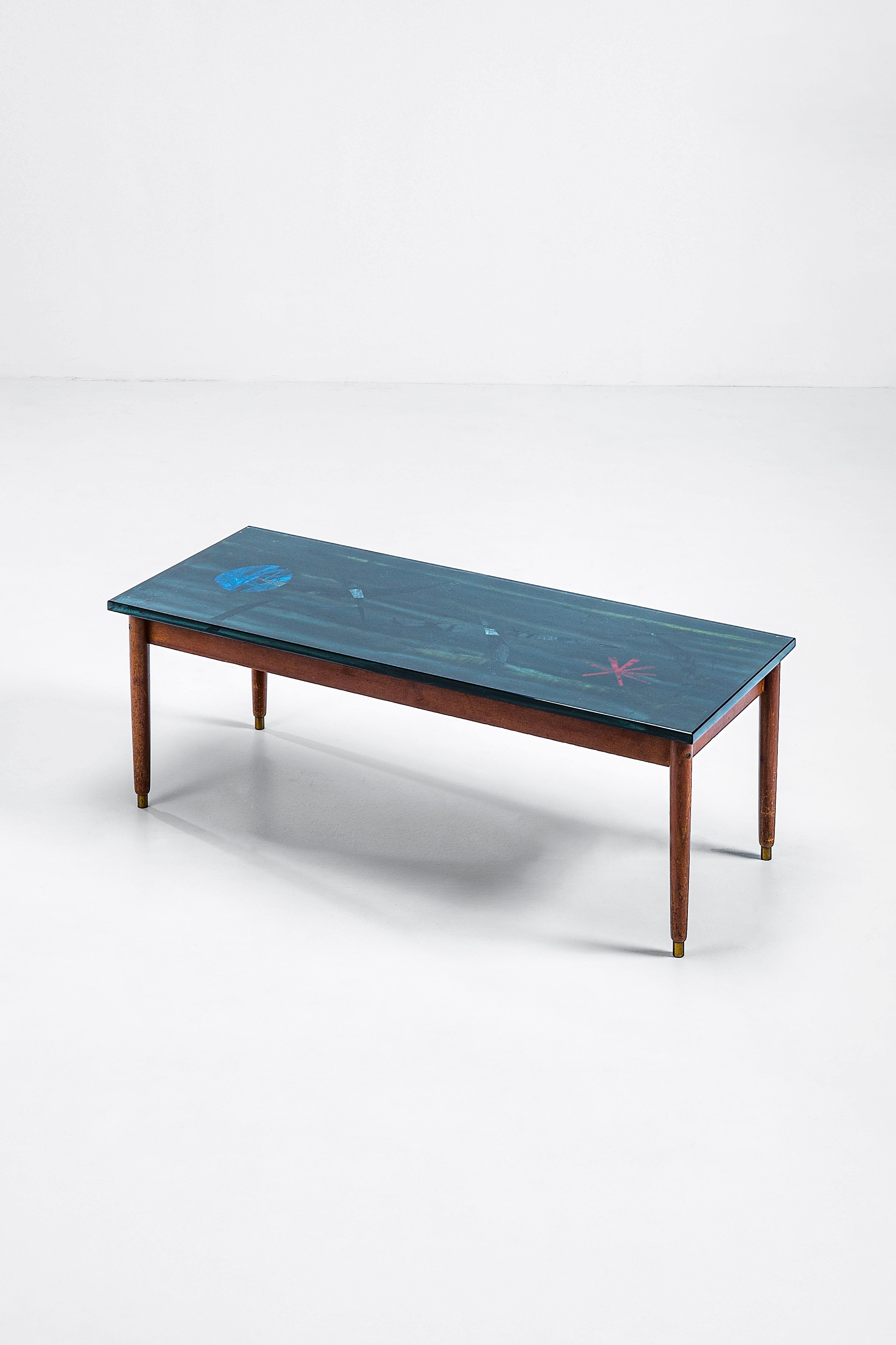 Duilio Bernabè known as Dubè was an artist who worked for Fontana Arte, among others, employing the eglomizing technique to decorate the painted back of glass panels and small tables. The distinctive asterisk signature on one edge helps validate the