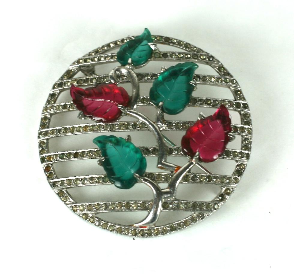 Dujay Art Deco Fruit Salad Brooch from the 1930's. An Art Deco plant with molded fruit salad leaves is set on a pierced pave gallery within a circular motif. Dujay items are frequently unsigned but are recognizable by their design and