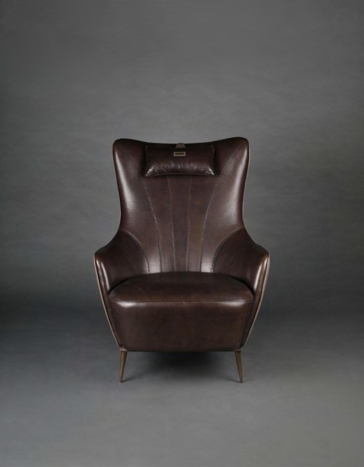 Duke leather armchair by Madheke.
Dimensions: W 97.2 x D 77.4 x H 106.2 cm.
Materials: Wood, leather, metal.

Leather upholstered back with deep leather upholstered seat and back. handstitched detail with neck cushion.

Reflecting the finest