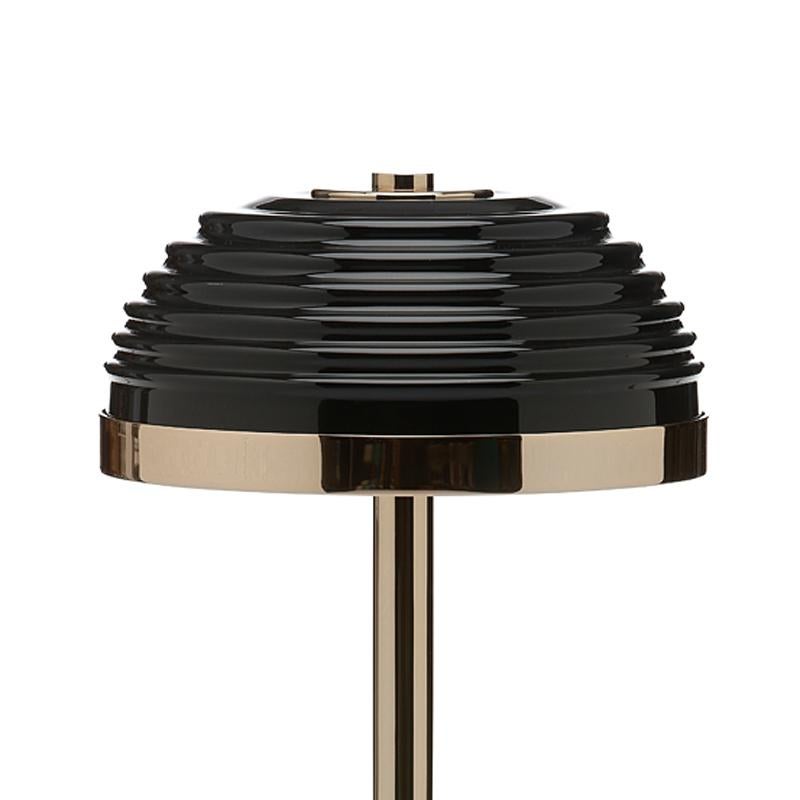 Table lamp duke with black glass shade,
with structure and base in polished solid
brass. With handblown smoked blackened
glass shade. With 2 bulbs, lamp holder type
E14, max 40 watt. Bulbs not included.
Subtle and elegant piece.
Also available