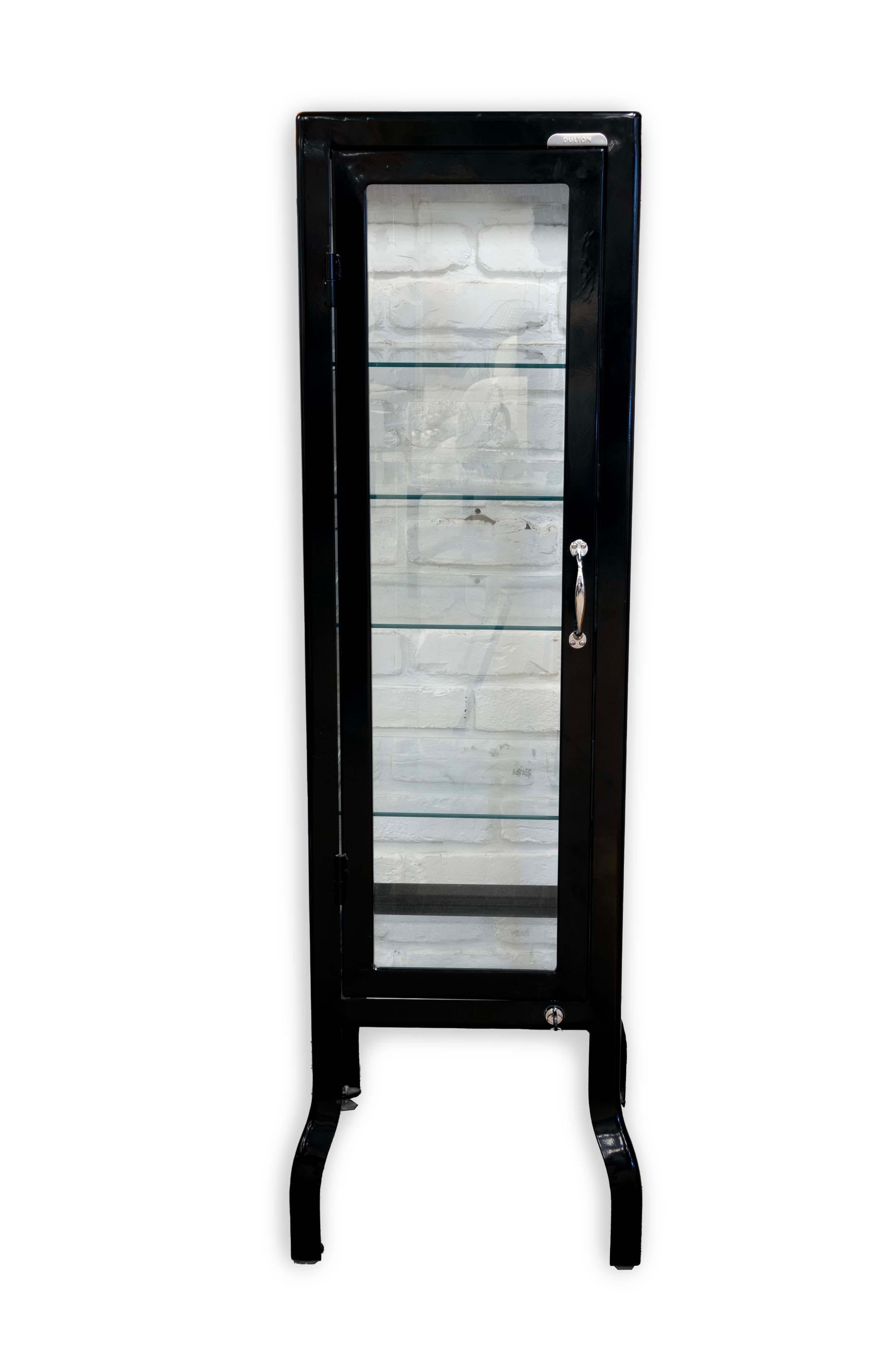 Chic and functional, this Dulton Vintage Metal and Glass Medical Dental Cabinet offers a striking blend of old-world charm and modern practicality. The sleek black metal frame complements the transparent glass panels, creating an elegant showcase