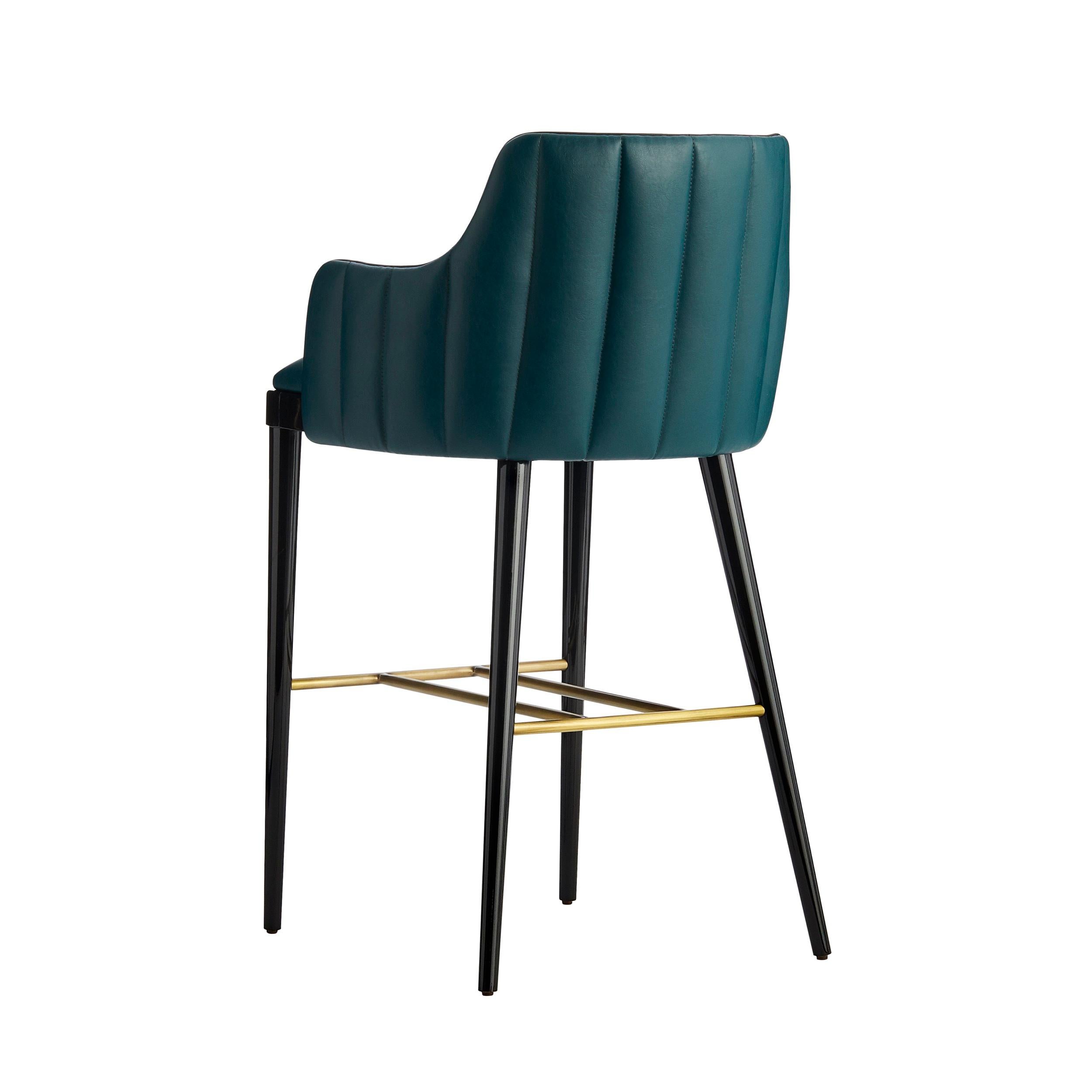 The DUMAS bar stool is a must for any living room.‎ Characterized by an elegant quilting, while the legs are lacquered and enriched with brass rest feet.‎ Dumas is available in fabric, natural leather, eco-leather or COM and is possible to customize