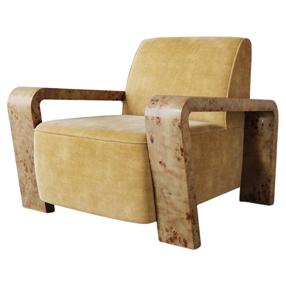 The Dumas Lounge Chair combines a clean, tightly tailored seat and back with wide Oak burl arms, creating a distinctive and inviting design. Its deep seat and curving legs pay homage to the Art Deco lounge chairs of the 1930s, mixing vintage