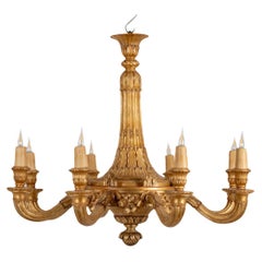 Aumez, lustre de style Louis XVI en bois sculpté et doré. 1950s.