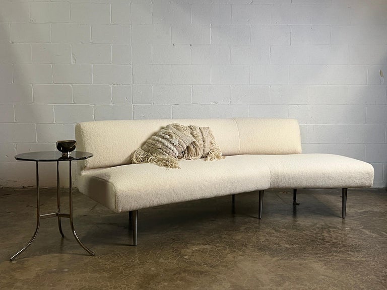 A gutter back armless sofa on aluminum legs. Designed by Edward Wormley for Dunbar. Fully restored and upholstered in faux shearling.