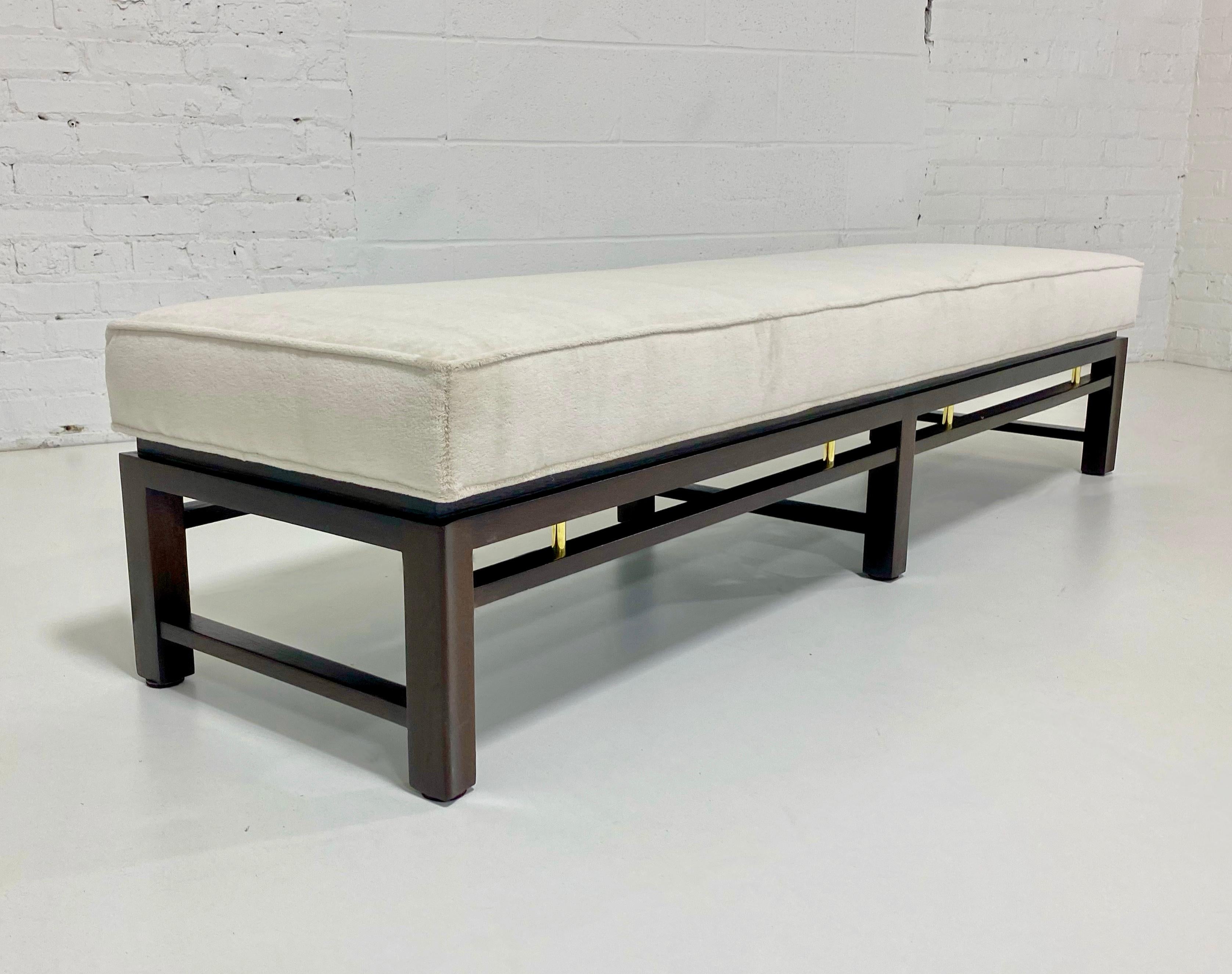 Bench by Edward Wormley for Dunbar. Espresso stained mahogany frame with brass details. Newly upholstered in creamy silk blend velvet. 
 