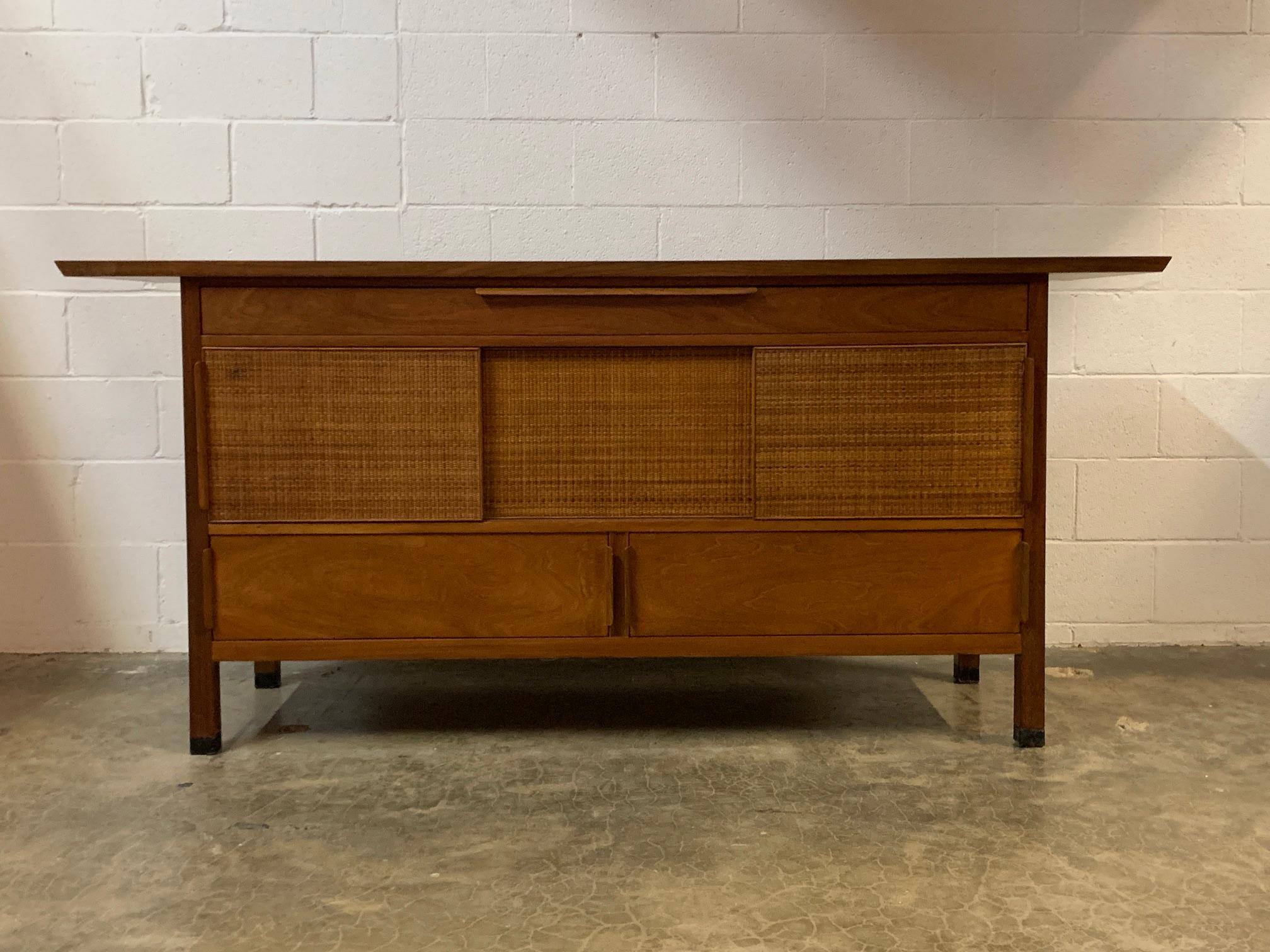 Edward Wormley for Dunbar cabinet with sliding cane doors and cantilevered top.