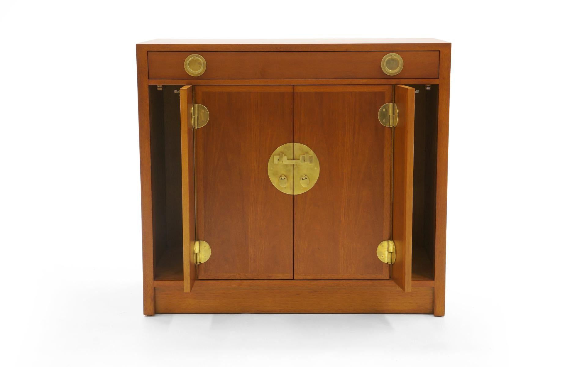 Storage chest or cabinet designed by Edward Wormley for Dunbar. Expertly refinished mahogany case with solid brass hardware. Two wide center drawers reveal an adjustable shelf. Two outer doors have the push and click opening mechanism. One wide