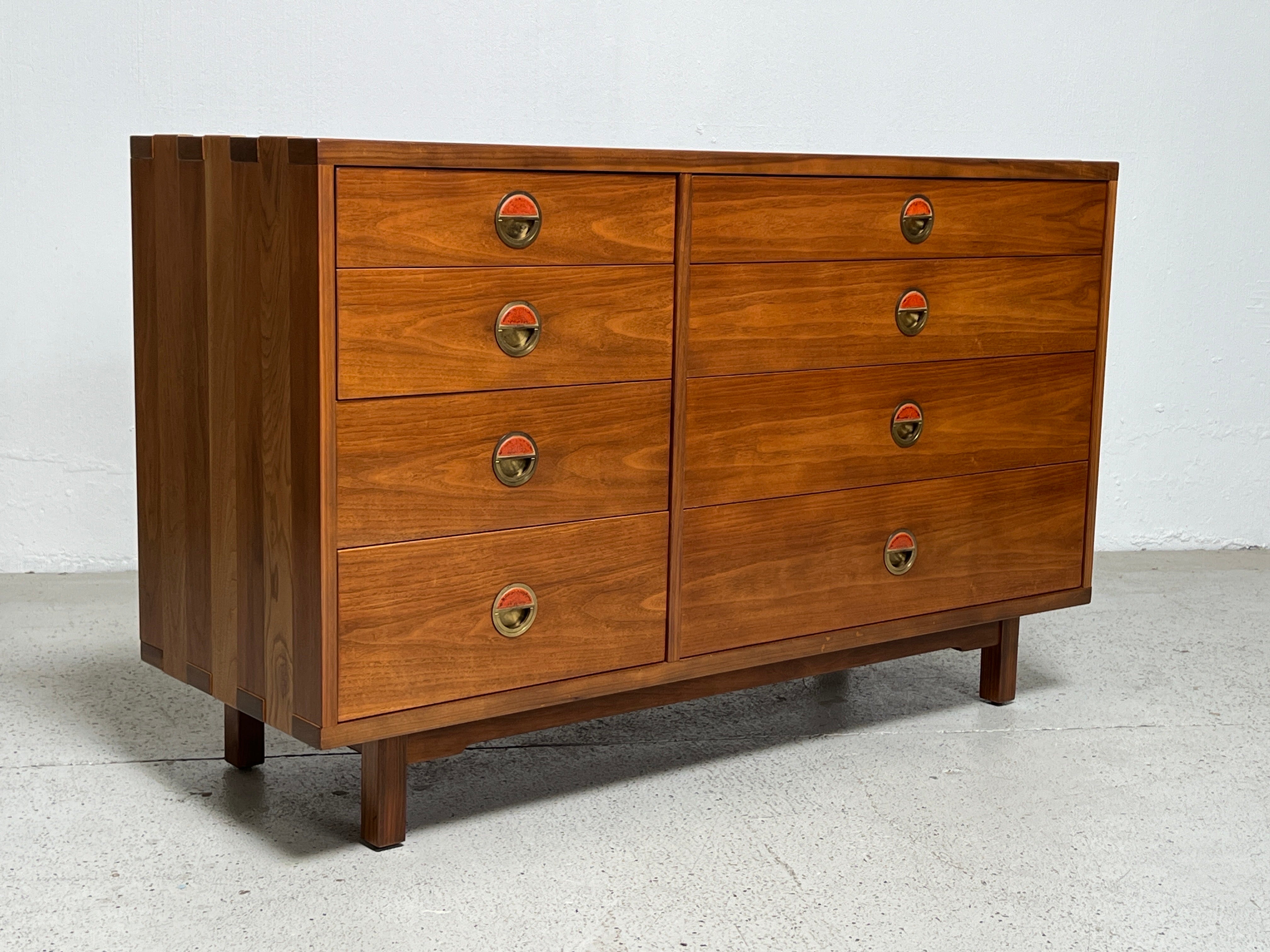 A rare chest designed by Edward Wormley for Dunbar. Solid walnut construction with exposed joinery and brass pulls with ceramic tiles by greta and Otto Natzler. Matching dresser available separately.
