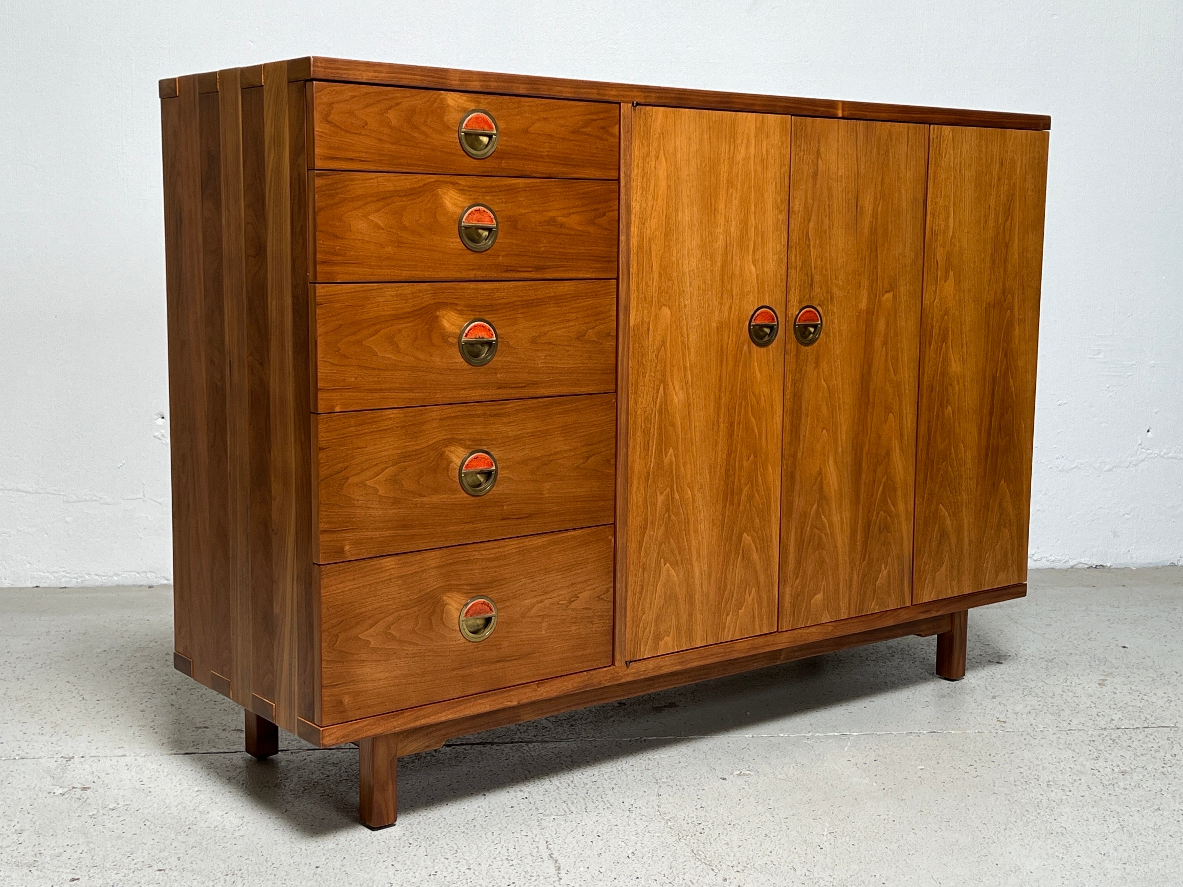 A rare chest designed by Edward Wormley for Dunbar. Solid walnut construction with exposed joinery and brass pulls with ceramic tiles by greta and Otto Natzler.  Matching dresser available separately. 