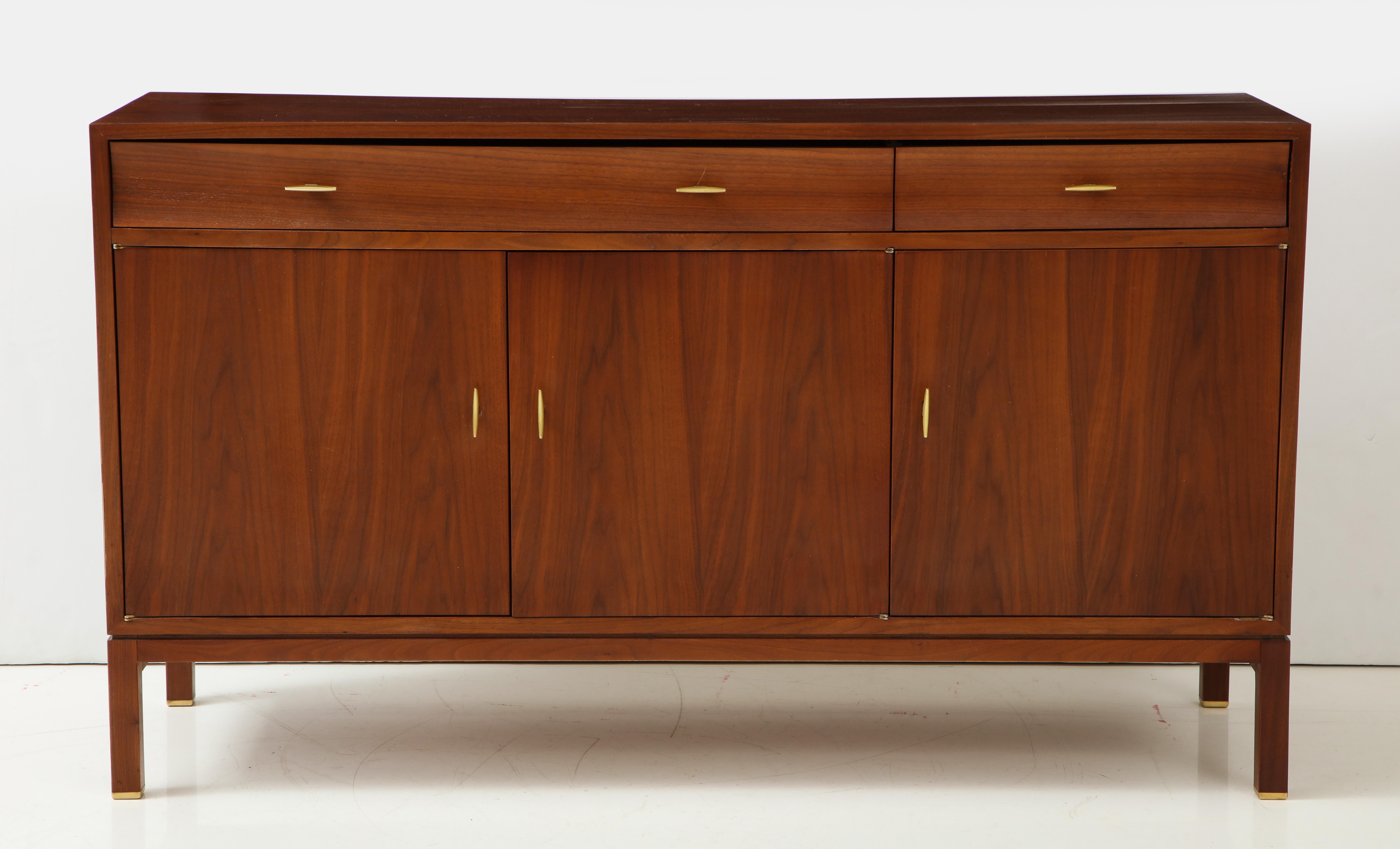 A great Edward Wormley for Dunbar Mid-Century Modern sideboard, credenza, with one large drawer, one cutlery drawer, two cabinets, the larger with shelves, and brass handles, brass plaque in drawer stamped 