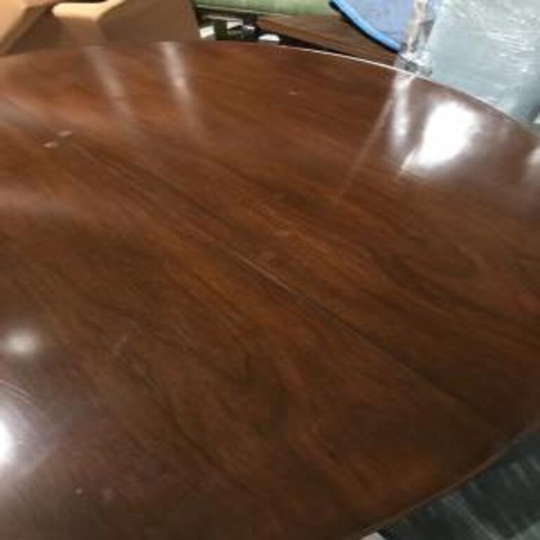 Exceptional Mid-Century Modern 1950s round wood dining table with extra leaf designed by Edward Wormley for Dunbar Furniture. Dunbar label is present on the underside of this piece. This table has few marks and scratches on the surface as you can