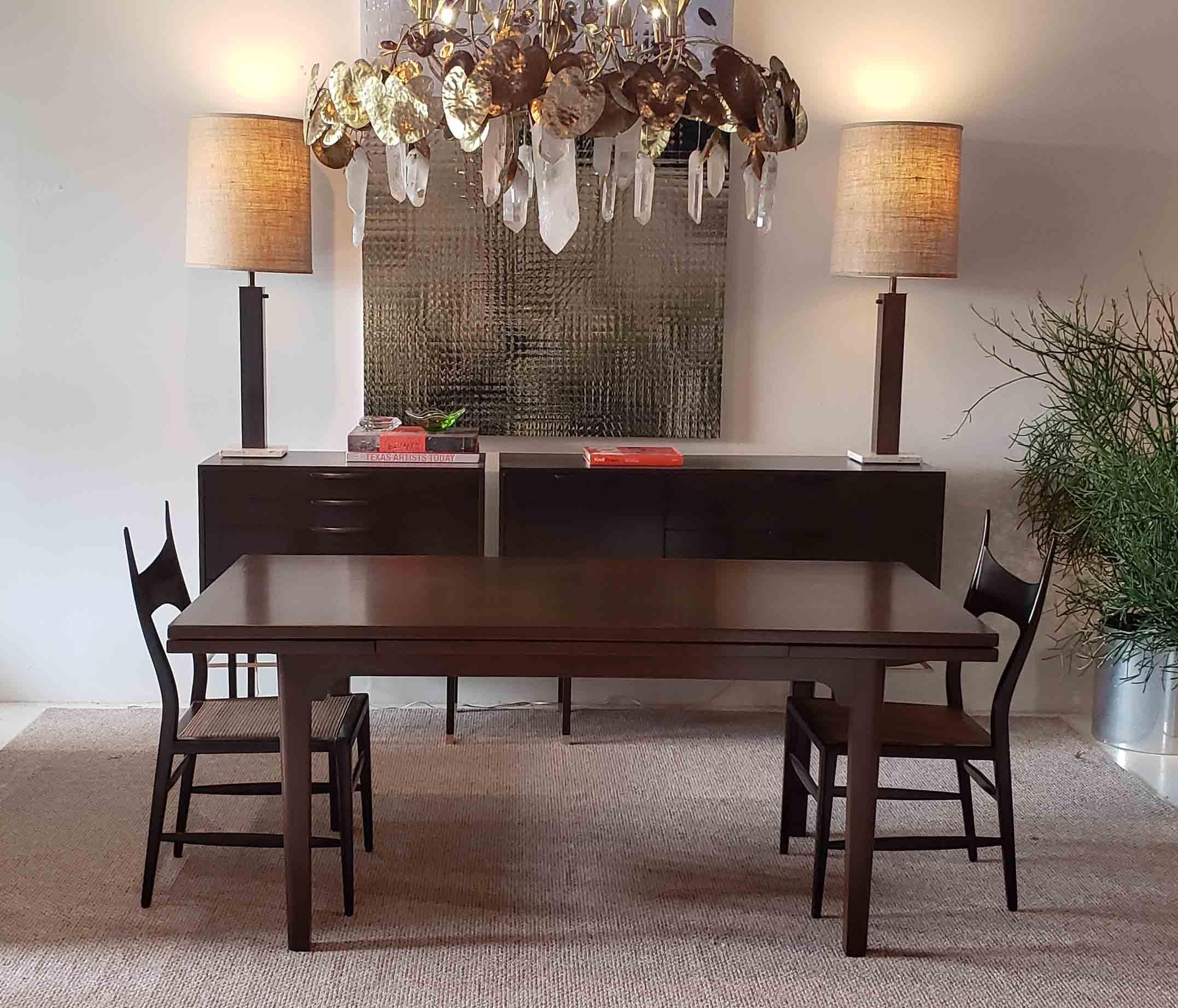 Dunbar dining table in a beautiful espresso stain with a clear satin lacquer finish. Completely restored. The leaves pull out and lock into position with the simple pull of one hand. A gorgeous and ingeniously engineered design.

The top measure