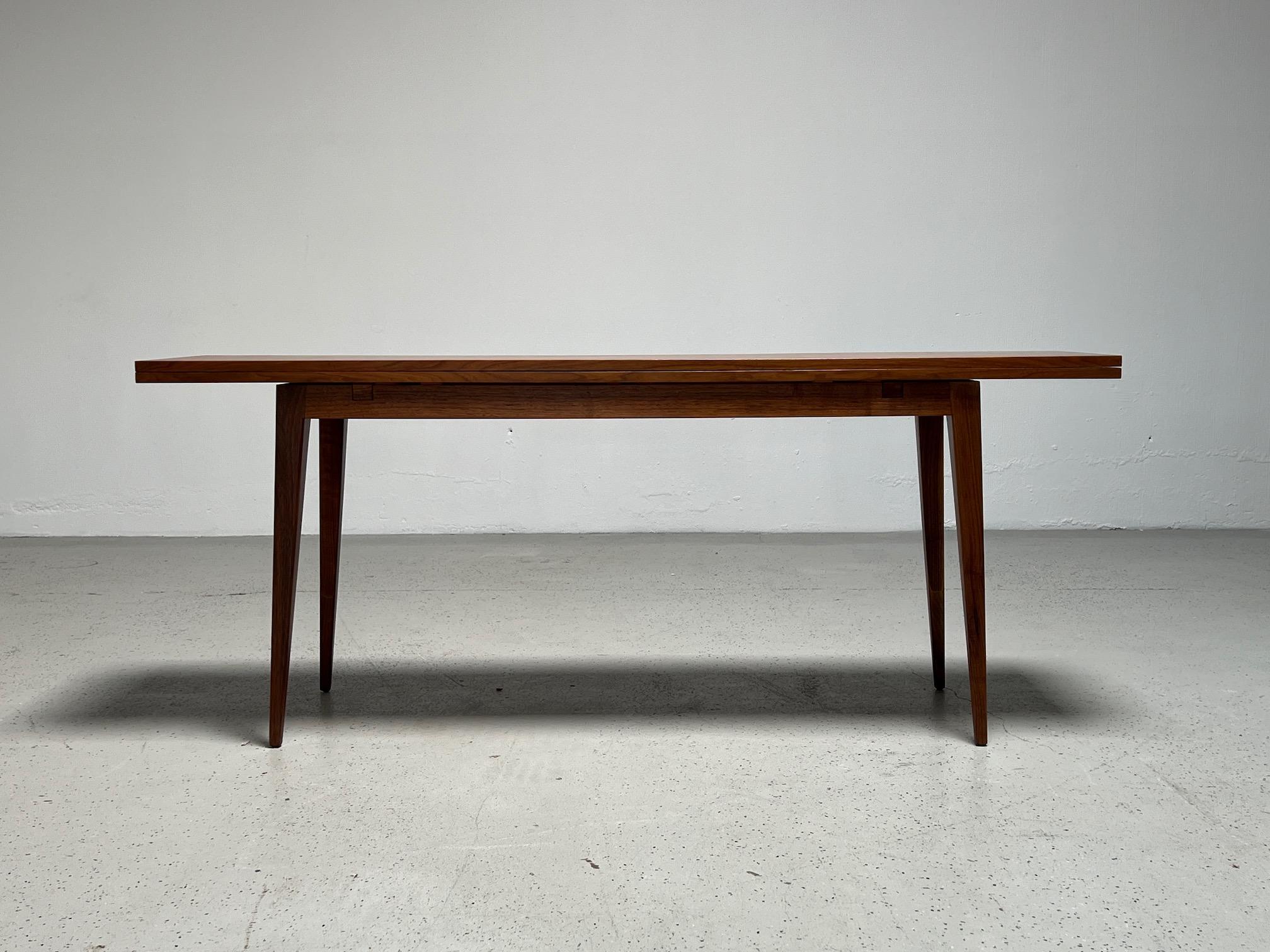 A walnut flip top console table designed by Edward Wormley for Dunbar. Measures 72 x 34 x 29 H when open.