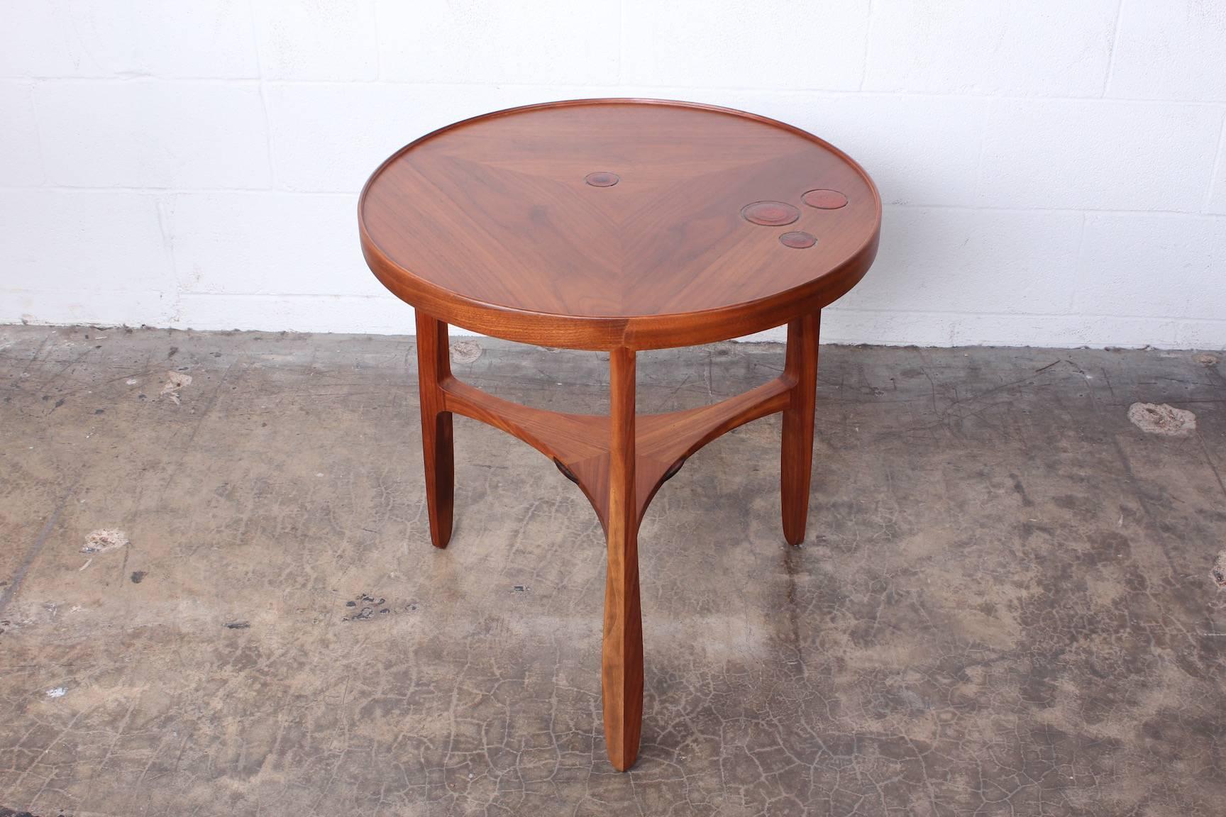 A walnut Janus table with inset Natzler ceramic tiles. Designed by Edward Wormley for Dunbar.