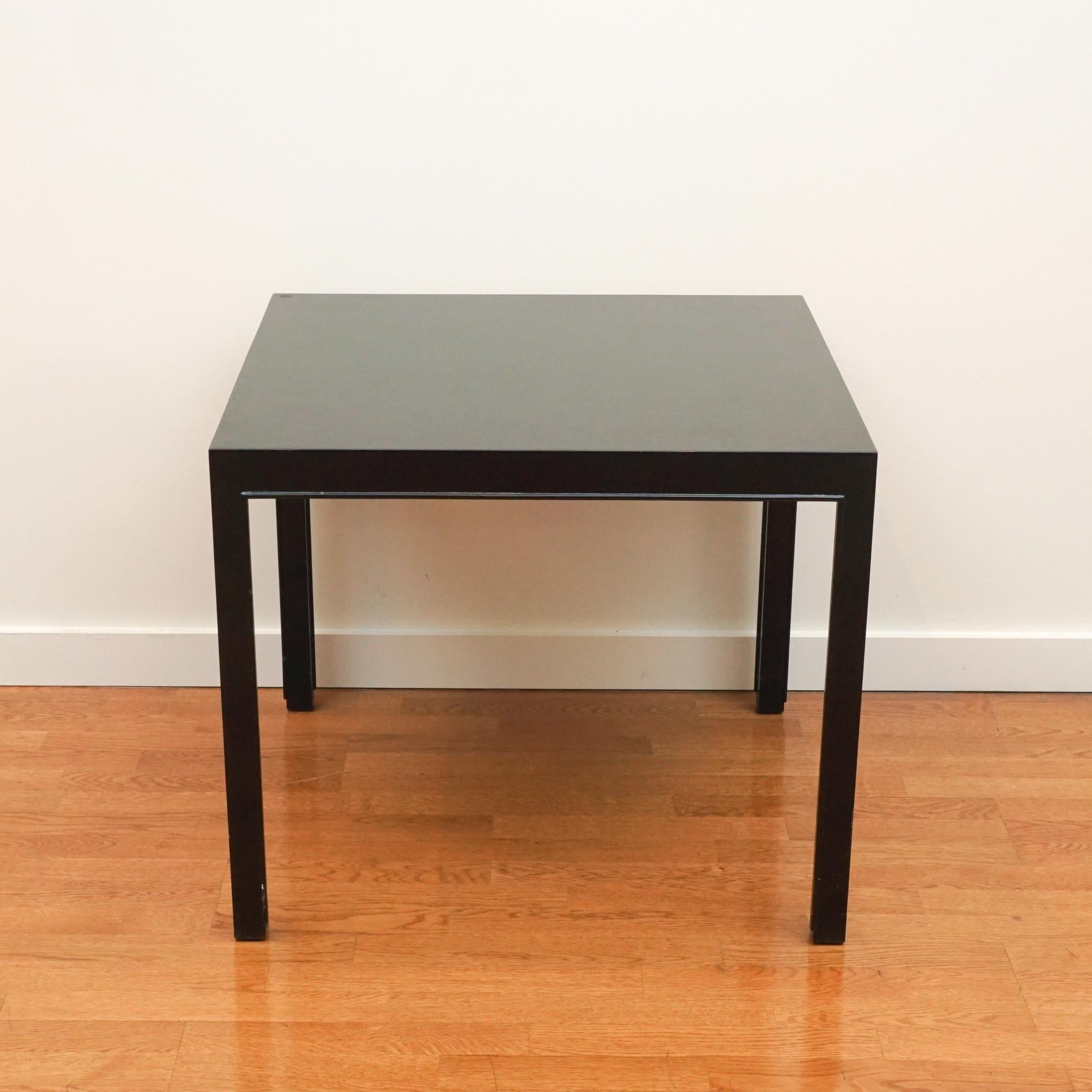 Simple lines and classic proportions make this square side table classic Dunbar. Made in the 1960s by the Indiana-based Dunbar Furniture company, the table is made of hardwood and finished in an ebony lacquer. The table bears the metal Dunbar marker