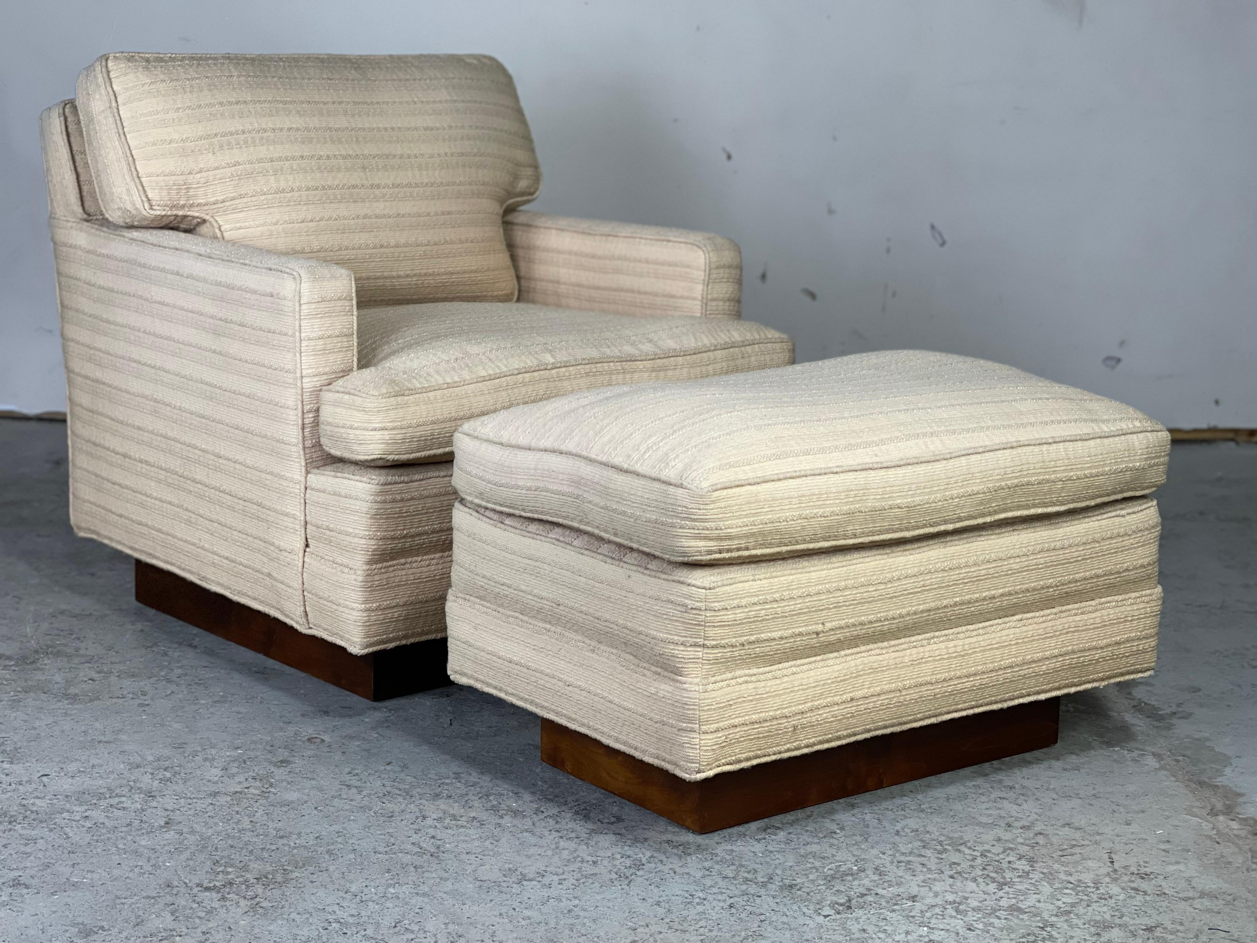 Classic Dunbar lounge chair and ottoman on custom ordered walnut plinth bases attributed to Edward Wormley for Dunbar Furniture Co. 
Duck down covered cushions - original upholstery is presentable and doesn't have stains but reupholstery is