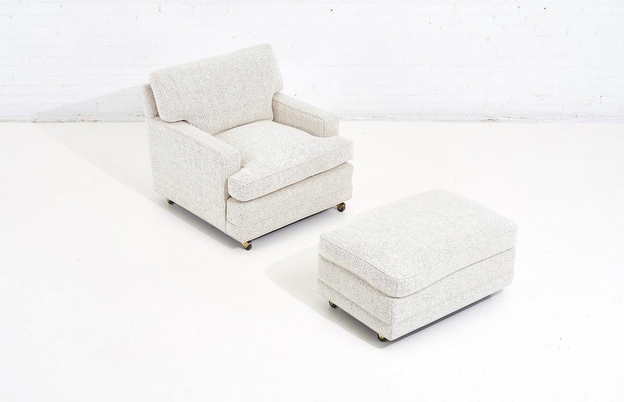 Dunbar lounge chair and ottoman upholstered in white boucle. Classic 1950’s Dunbar set. Designed by Edward Wormly. Fully restored and reupholstered in Holly Hunt wool boucle with white leather piping.