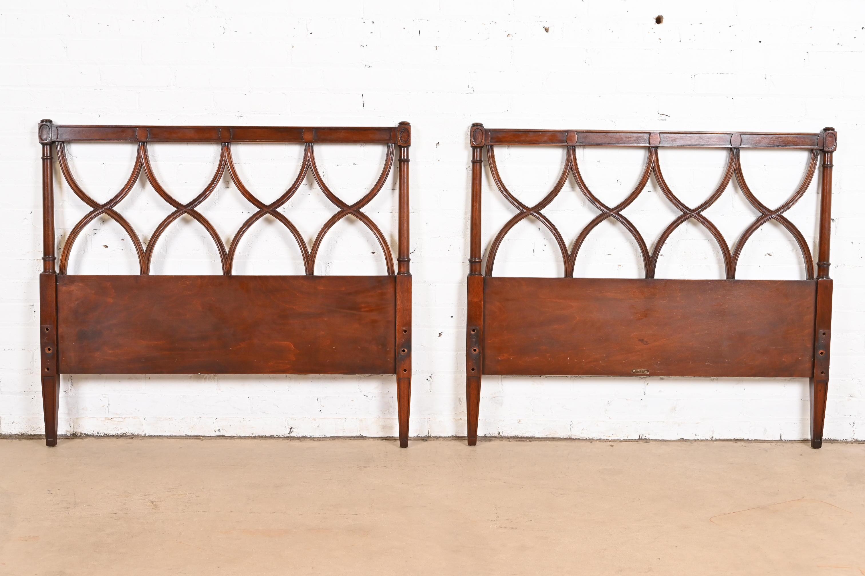 A gorgeous pair of mid-century French Regency Louis XVI style carved mahogany twin size headboards

By Edward Wormley for Dunbar

USA, Circa 1940s

Each measures: 41.75