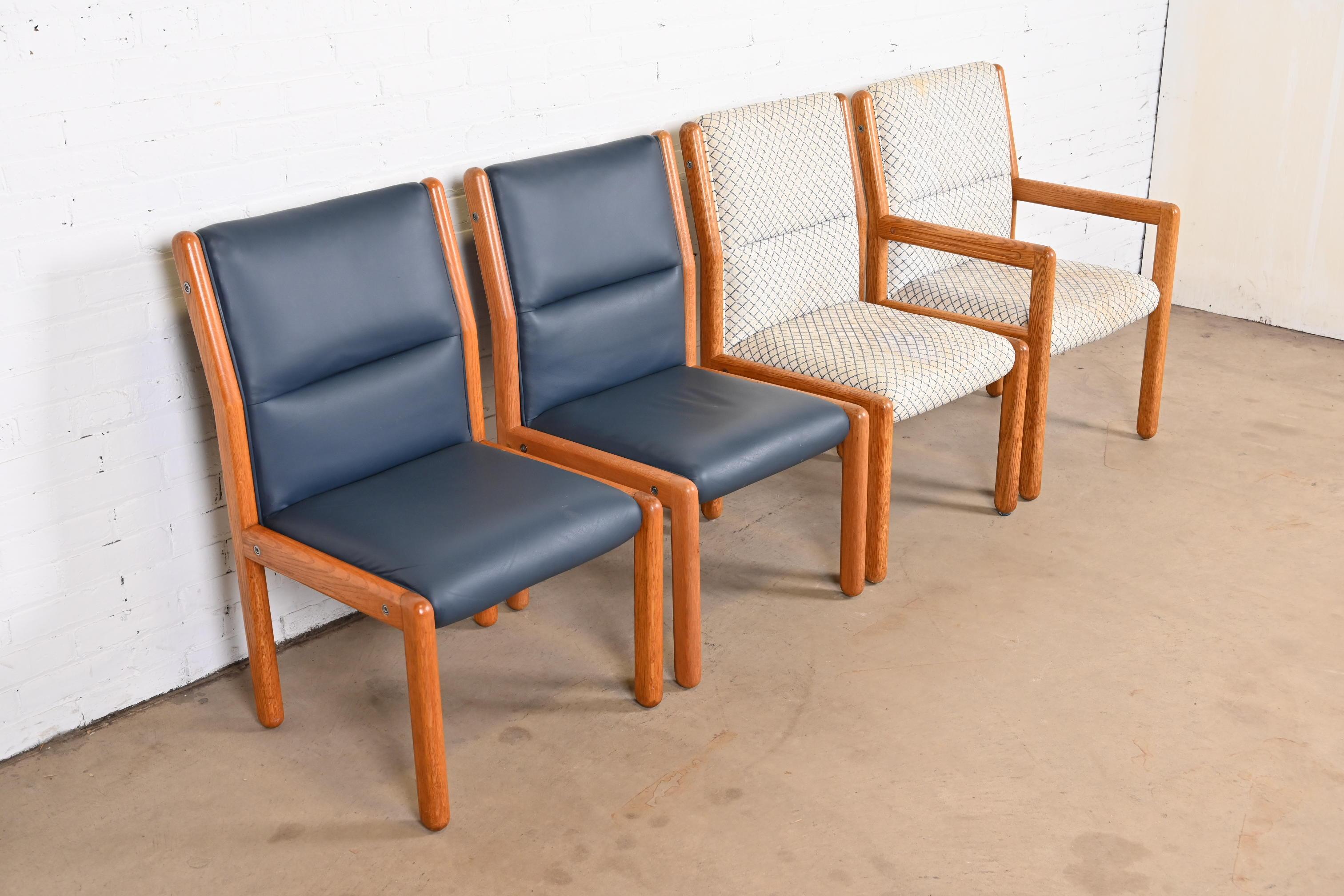 A nice set of four Mid-Century Modern dining chairs

By Dunbar Furniture

USA, 1970s

Solid oak frames, with upholstered seats and backs. Two chairs with high end blue leather upholstery.

Measures:
Side chairs - 21.5