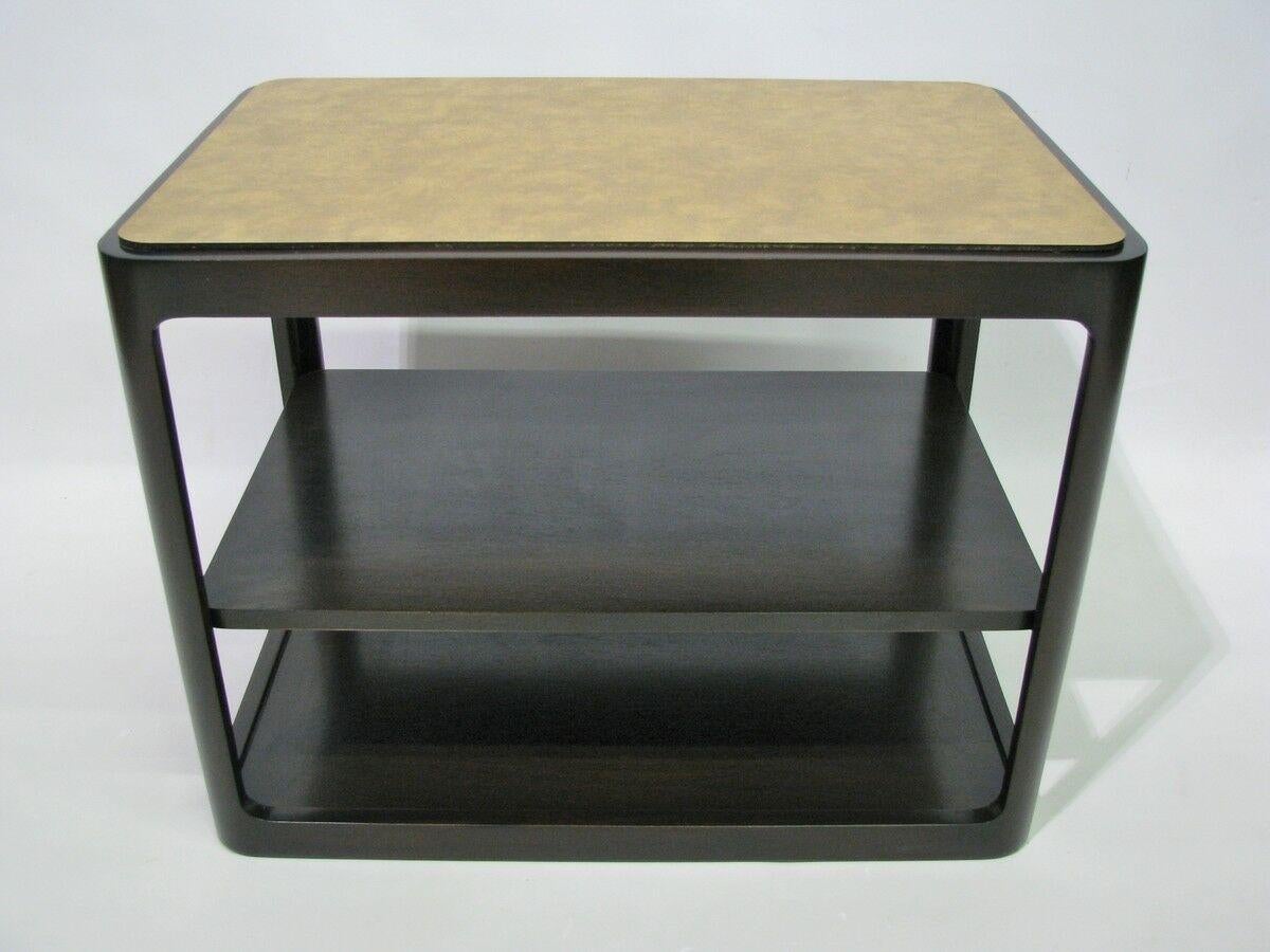 A single end table with rectangular shape and an adjustable middle shelf by Edward Wormley for Dunbar. USA, 1975. Features a tooled leather top.

Beautiful espresso/dark chocolate brown satin finish.

Signed with Dunbar burnished ink stamp to