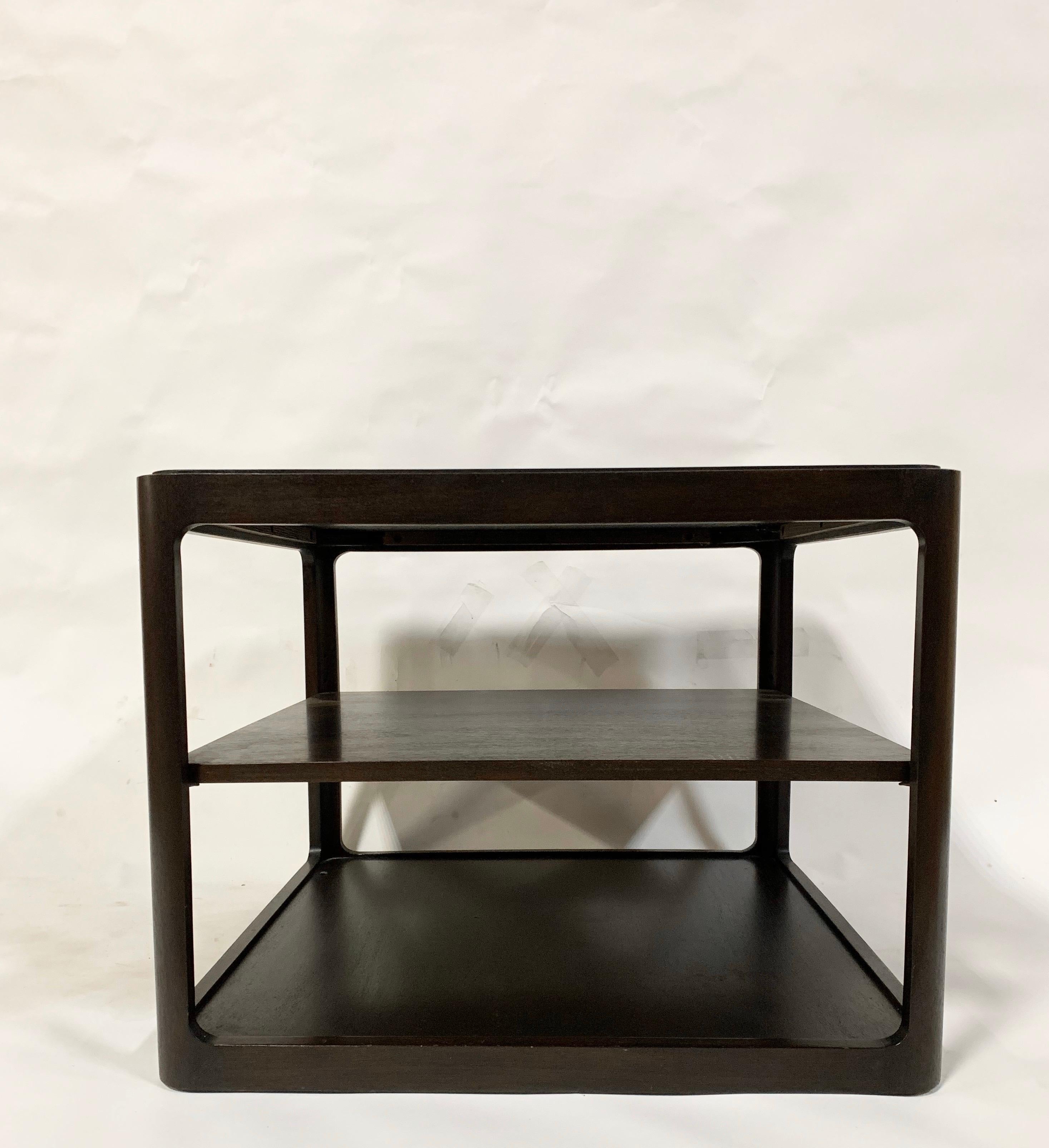 A square top end table with adjustable middle shelf. By Edward Wormley for Dunbar. USA, 1975. Signed/dated with metal Dunbar tag and paper label to underside.

Beautiful original espresso / dark chocolate brown satin-finished mahogany.

Price