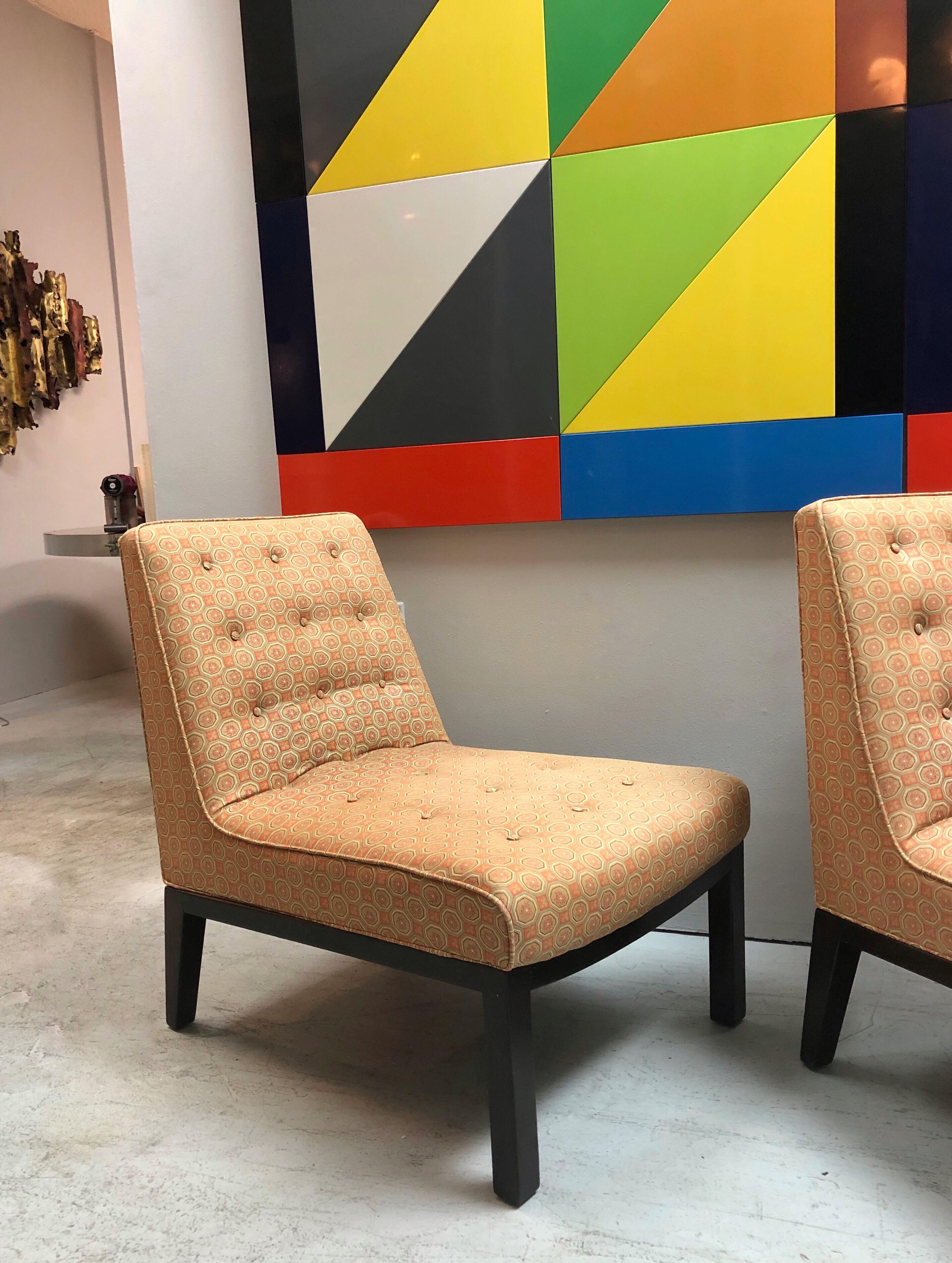 A pair of stylish lounge chairs design by Edward Wormley for Dunbar. Original upholstery. Both retain Dunbar metal tags.