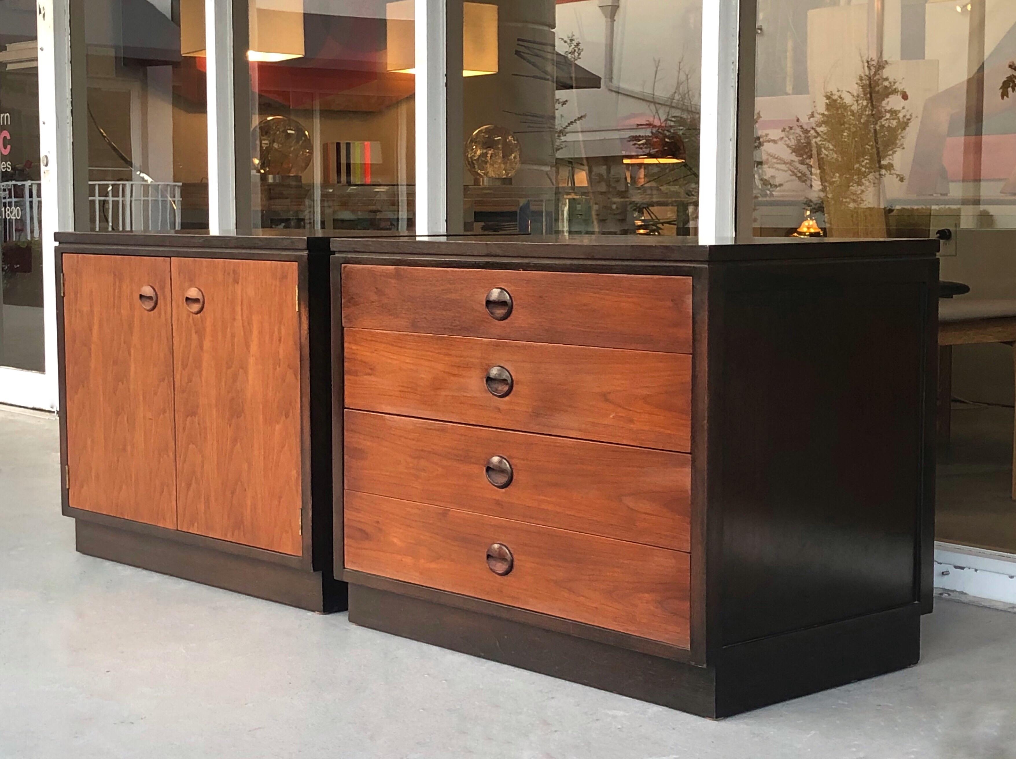 A pair of bedside tables by Dunbar. A very convenient size and design. One has 2 doors that reveal an adjustable shelf. The other one has 4 drawers.