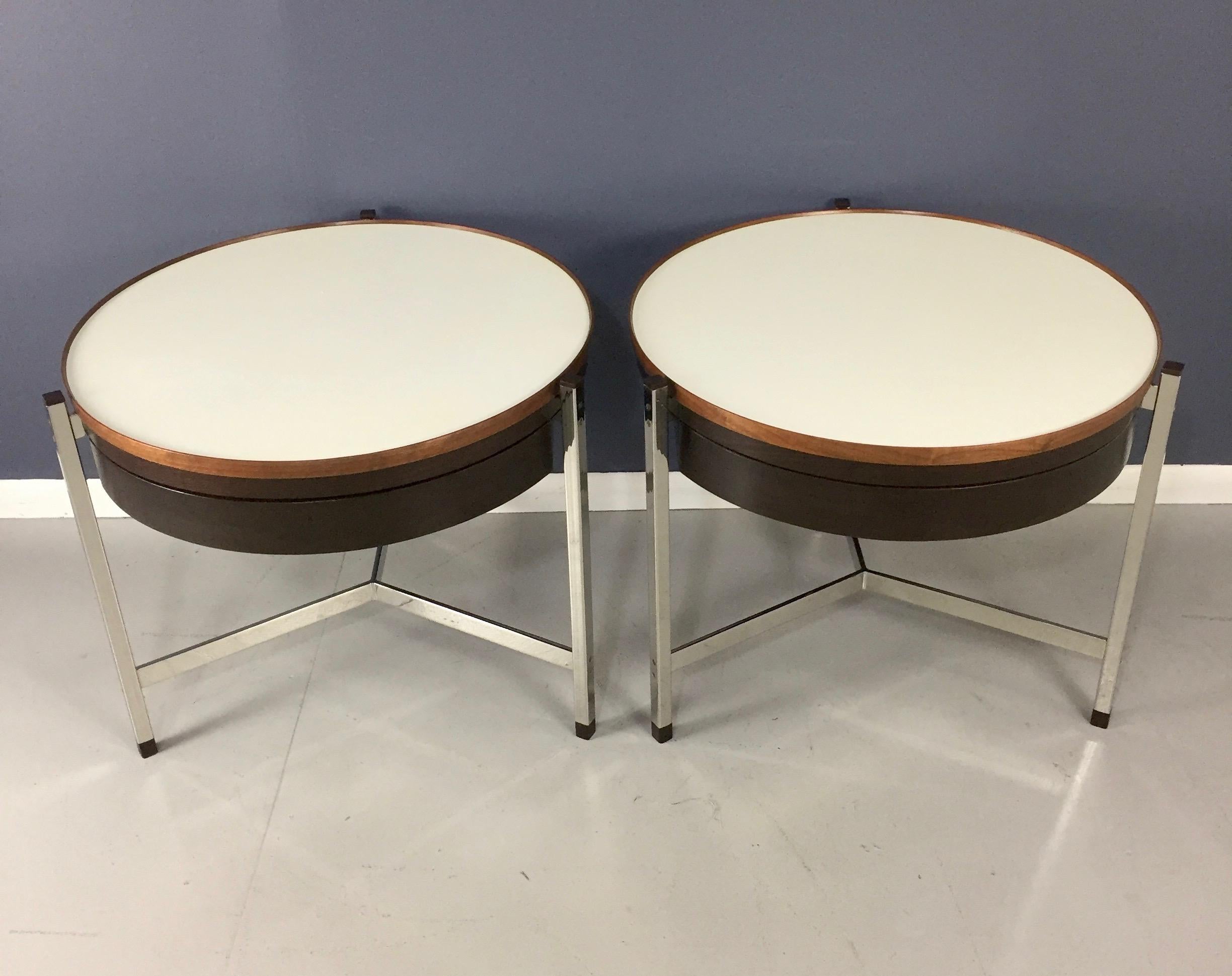 A pair of exceptionally rare and unusual round occasional tables in walnut and rosewood with Micarta tops and stainless steel structure. Tables with a single drawer and rosewood feet and caps.

These tables have gone through an extensive