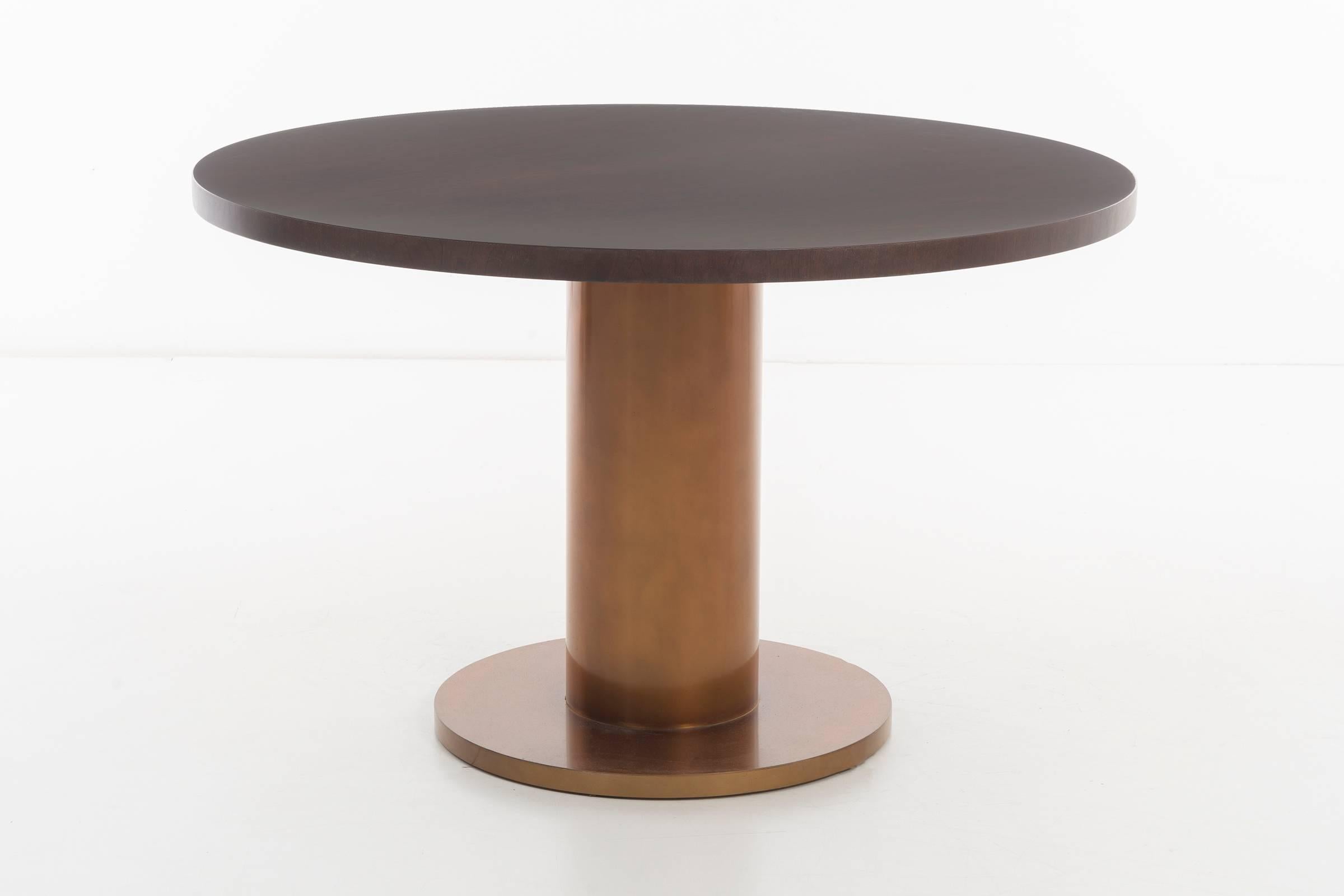 Edward Wormley for Dunbar dining/centre table.
Model 5474 with Tawi wood stained top and bronze base.
Restored, base and refinished top.
Applied brass tag on underside [DUNBAR*BERNE INDIANNA].