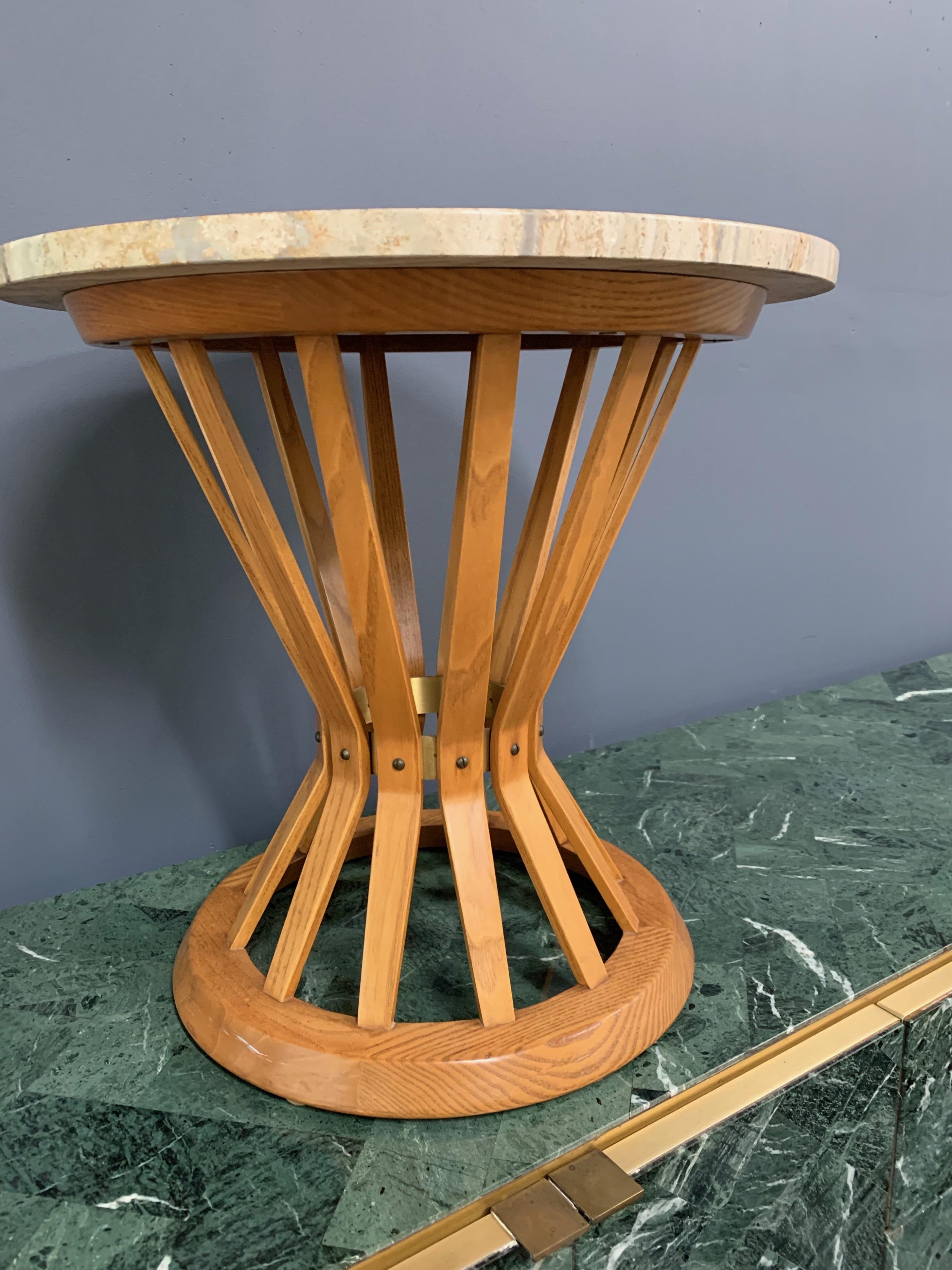 All original table in warm oak and travertine top by Dunbar Furniture Co. This is an iconic design from the 1950s. This table is in all original condition and very handsome.

This piece is from that extraordinary period when Harvey Probber, Vladimir