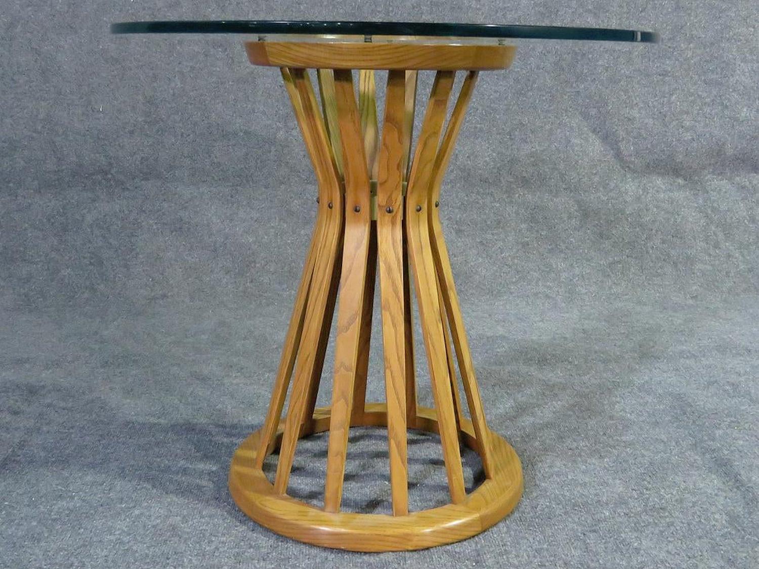 Mid-Century Modern round glass table with oak base.
(Please confirm item location - NY or NJ - with dealer).
   